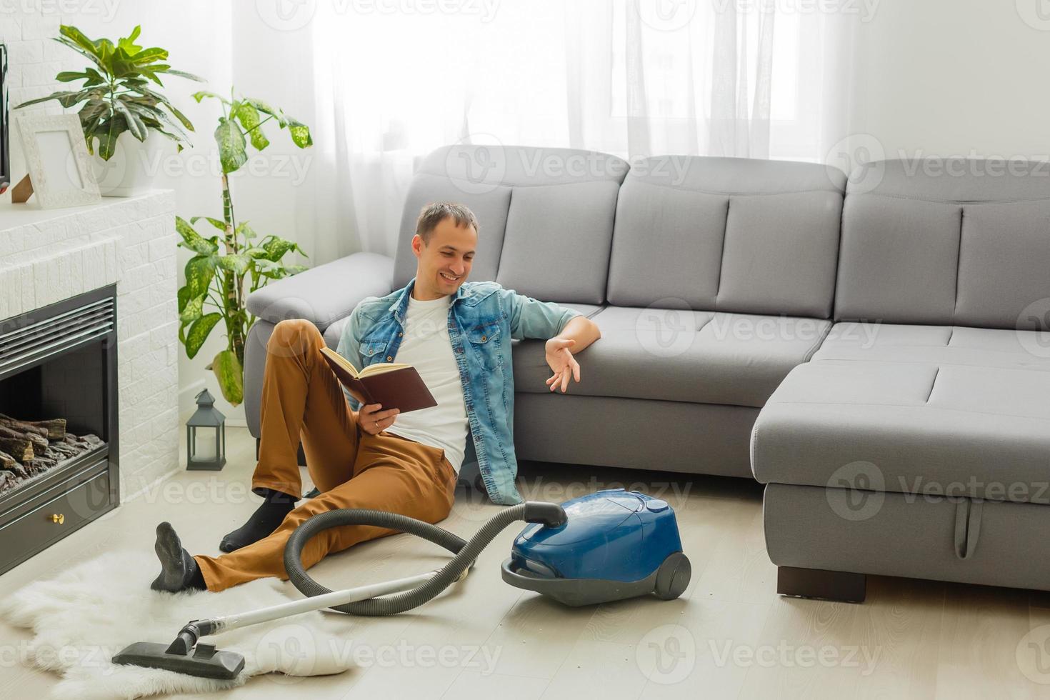 Coronavirus pandemic. A man with a vacuum cleaner in his apartment. Home Office. Quarantine. Remote work. A man in a business shirt and underpants holds. photo