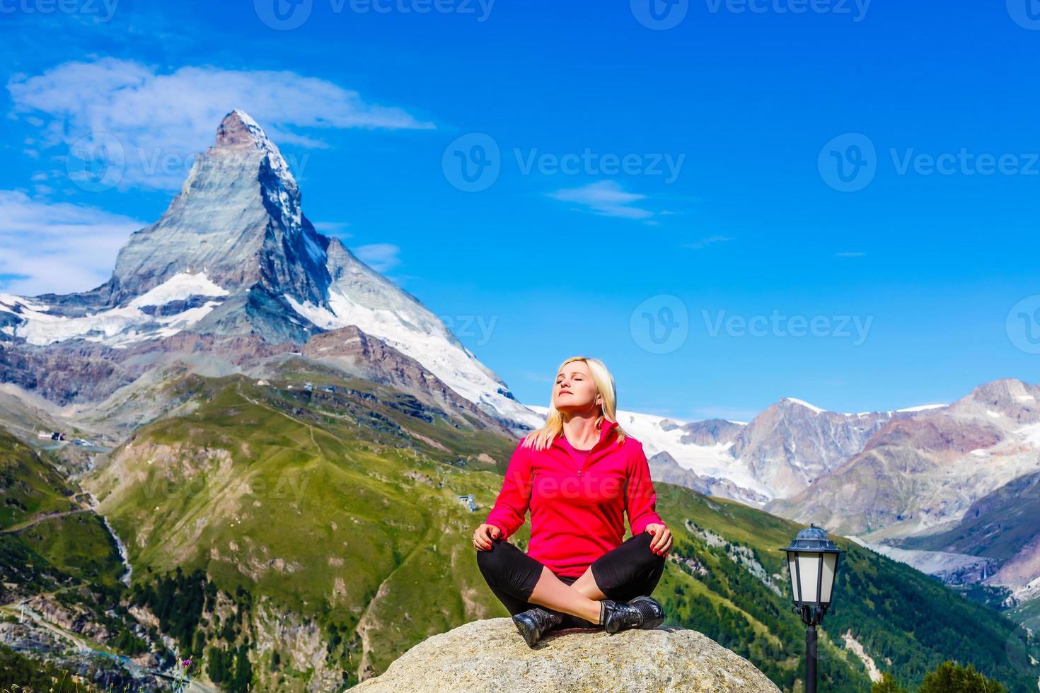 women meditating on high mountain in sunset background photo