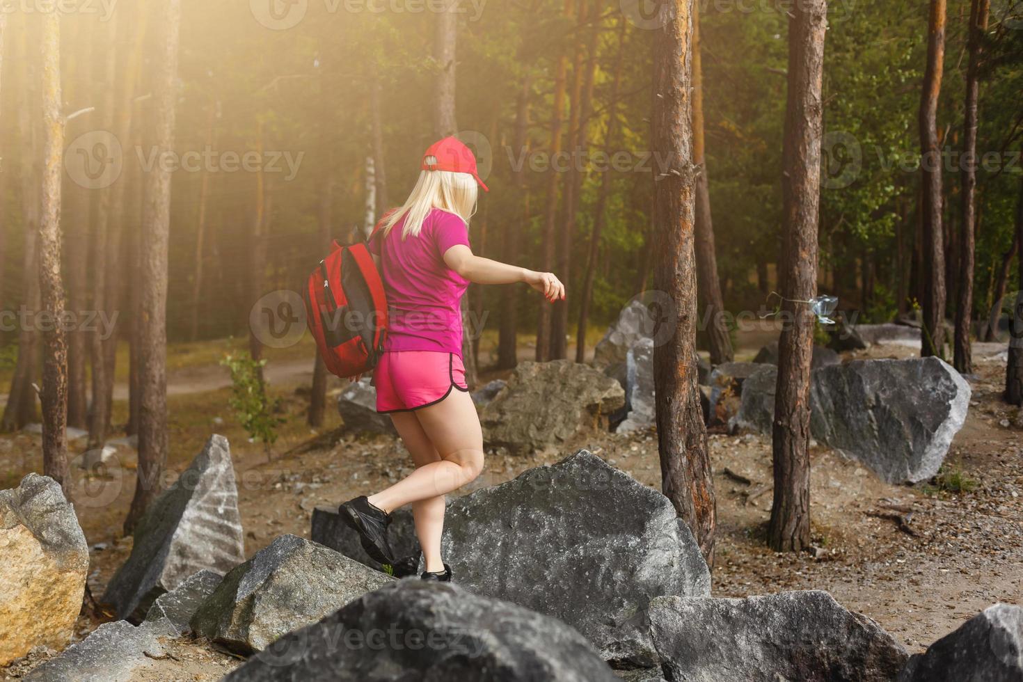stylish hipster woman with backpack looking at amazing woods and mountains in summer, travel concept, space for text photo