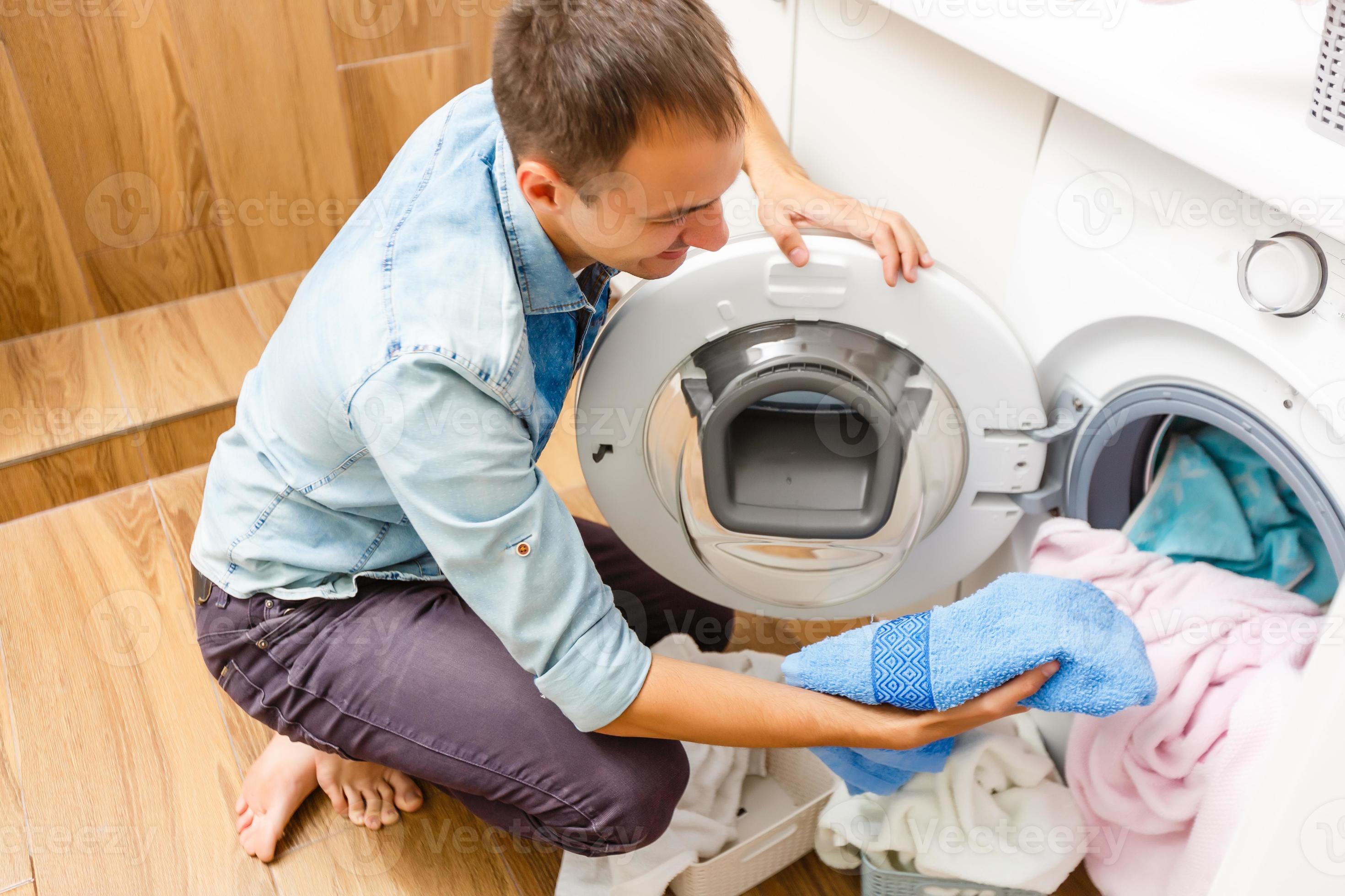 A detail of a male putting in a load of laundry 16781960 Stock Photo at