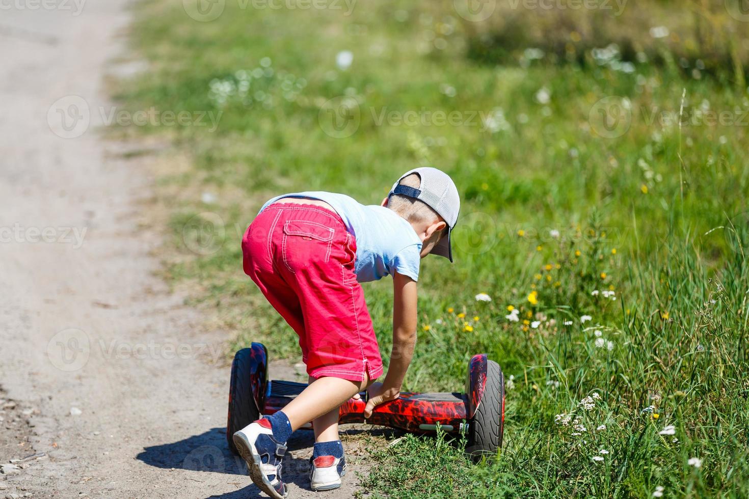 Little boy riding electrical scooter photo