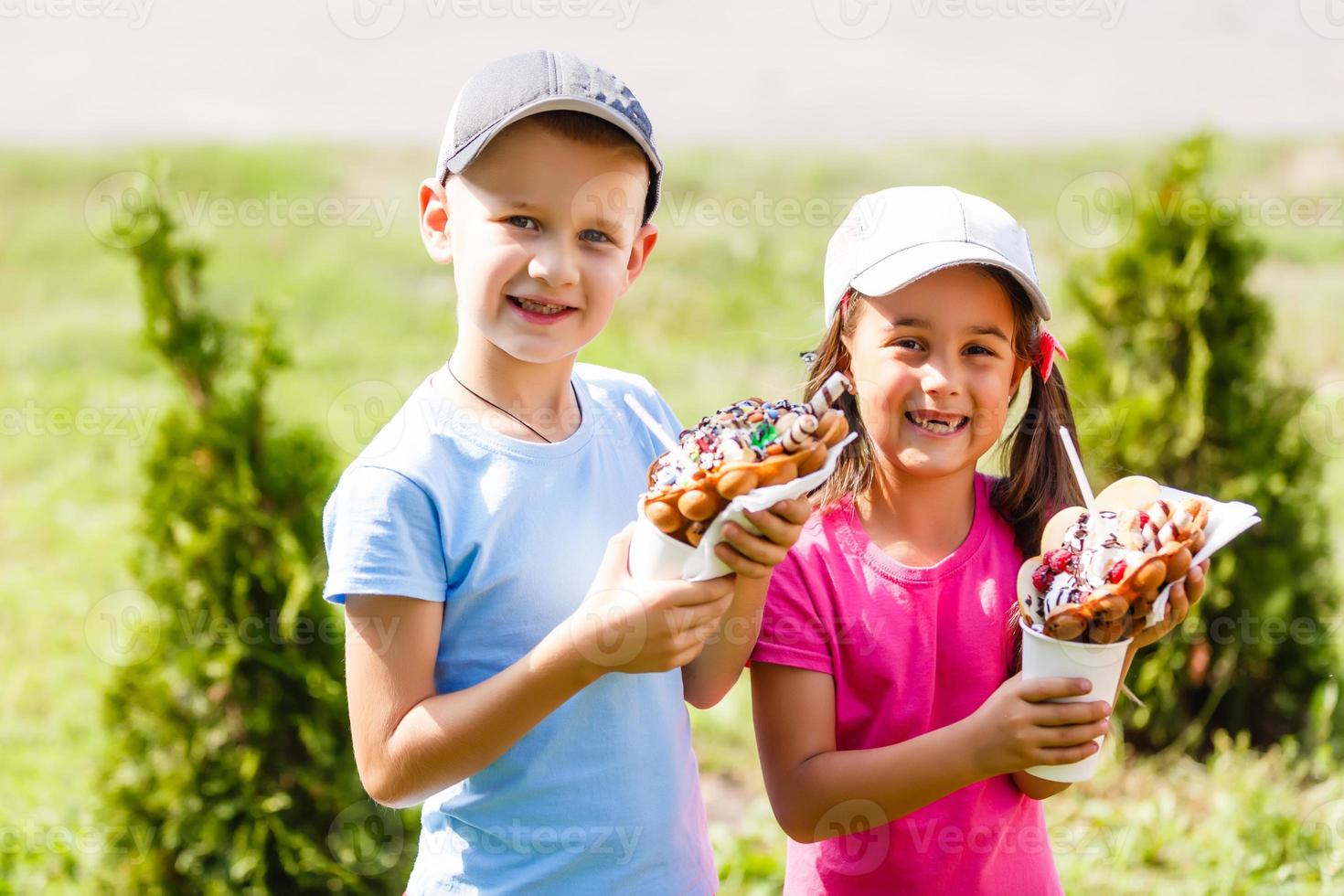 kids eating bubble waffle with ice cream photo