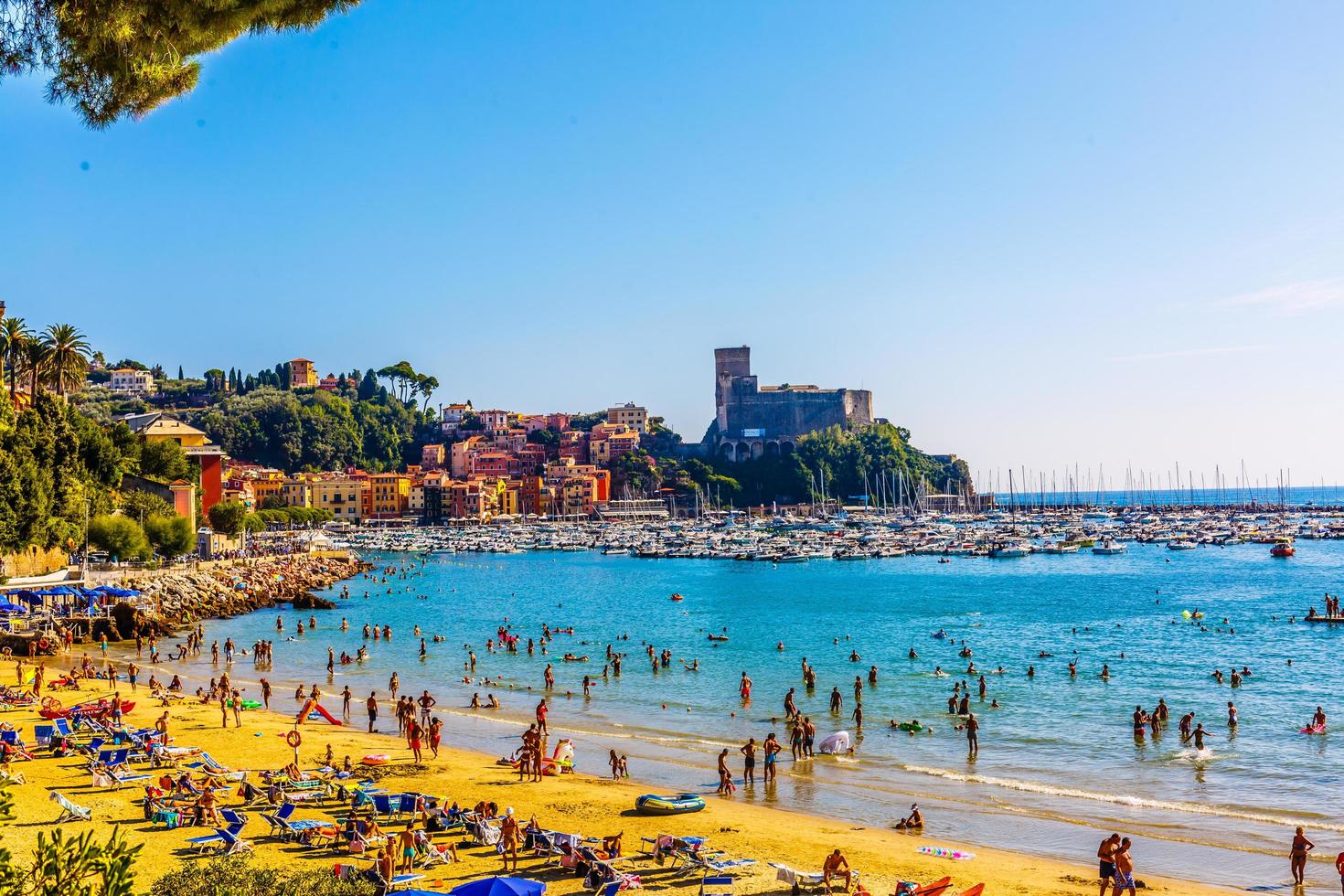 19.08. 2019  Lerici. Liguria. Italy. Beach with many umbrellas and very busy in the summer on the Ligurian coast. photo