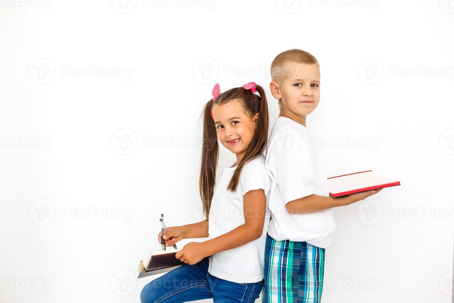 Children's fashion. Modern boy and girl posing together at studio. Education. photo