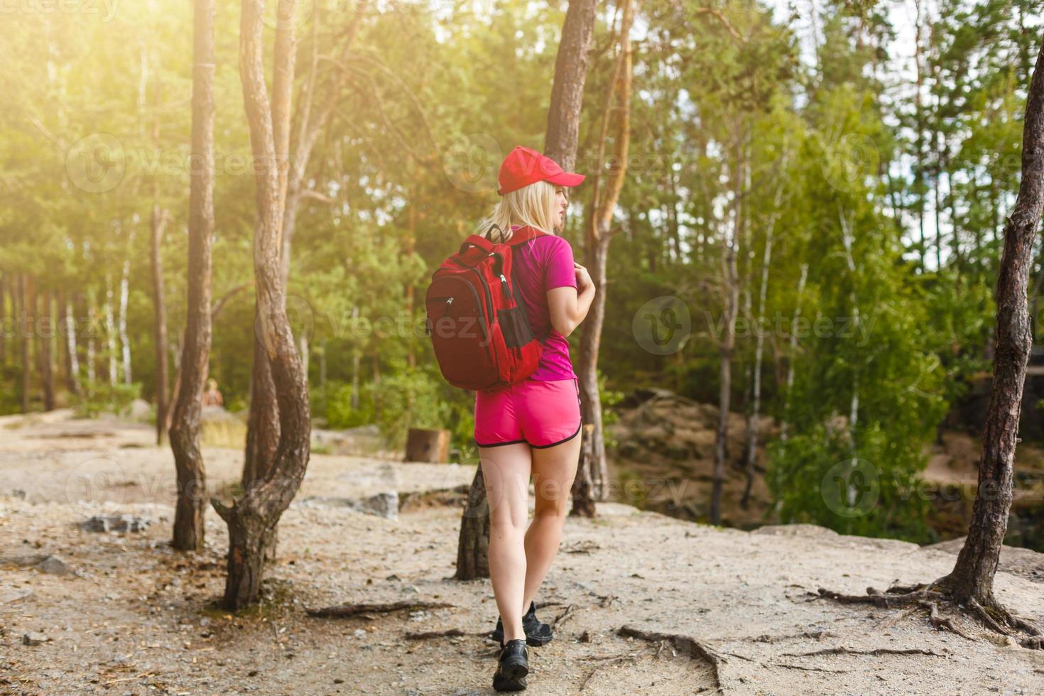 stylish hipster woman with backpack looking at amazing woods and mountains in summer, travel concept, space for text photo