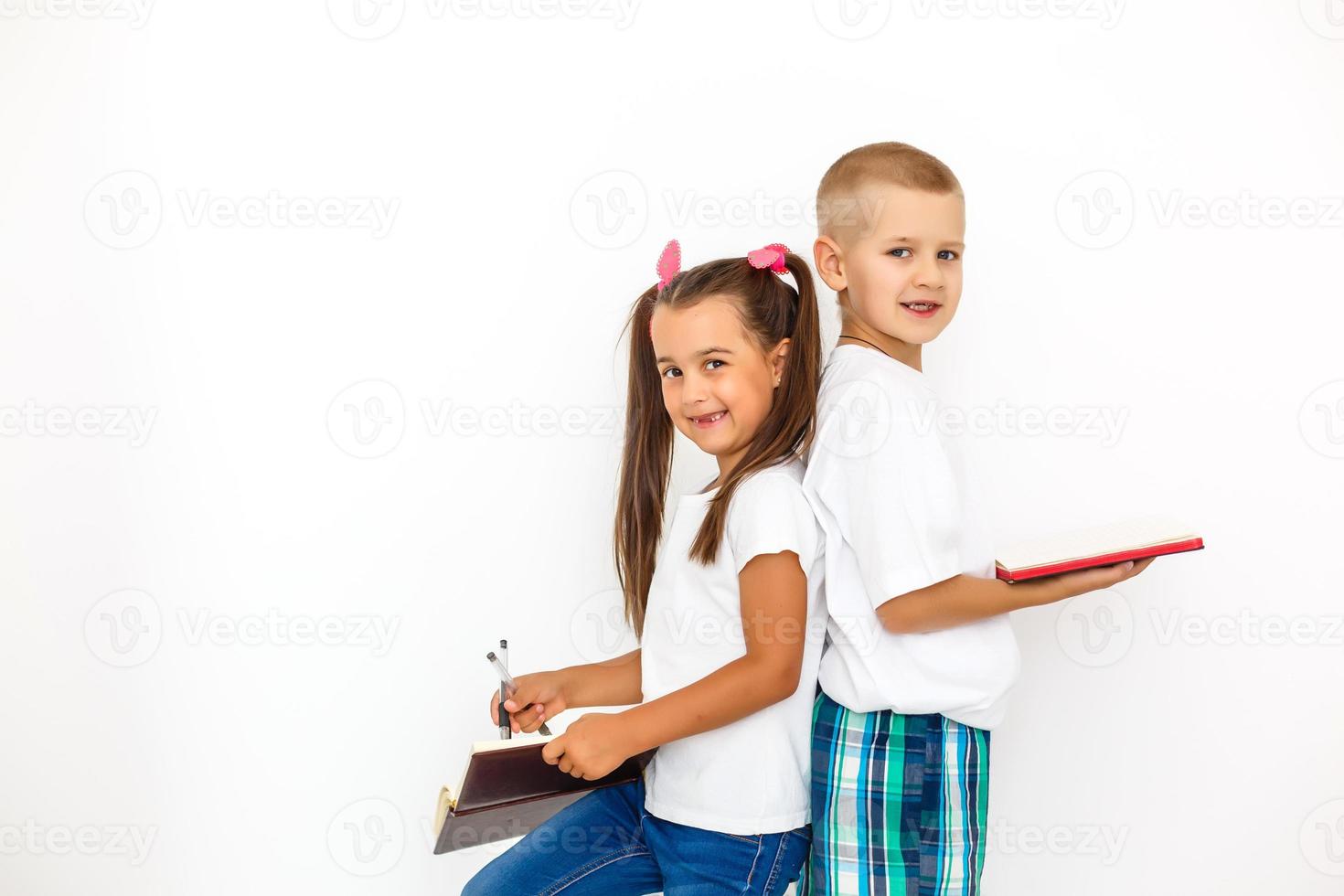 Children's fashion. Modern boy and girl posing together at studio. Education. photo