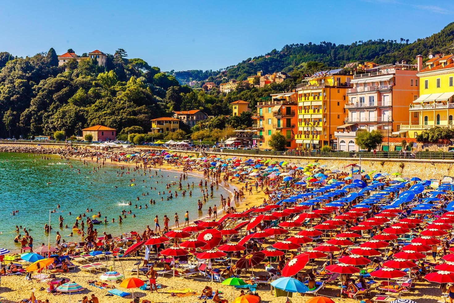 19.08. 2019 - Lerici. Liguria. Italy. Beach with many umbrellas and very busy in the summer on the Ligurian coast. photo