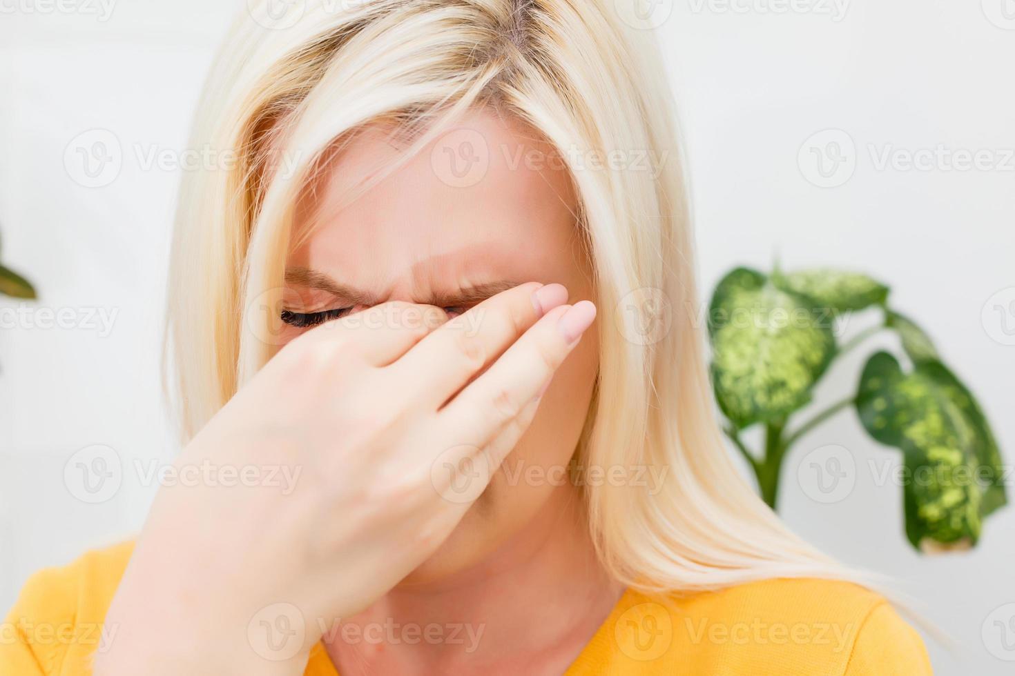 Tired young woman suffering from migraine. photo