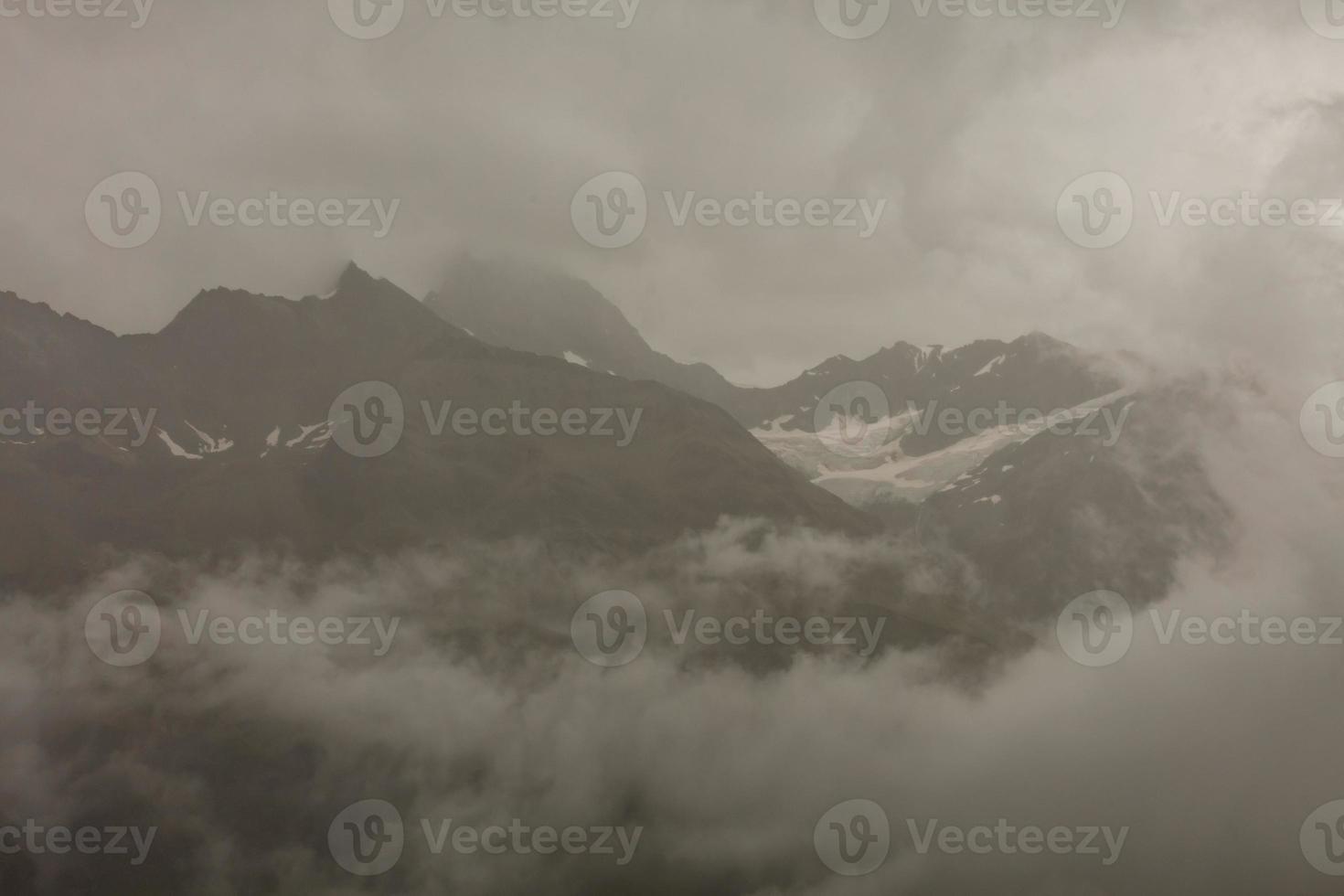 Panorama of cloud layer from mountain top over Swiss alps photo