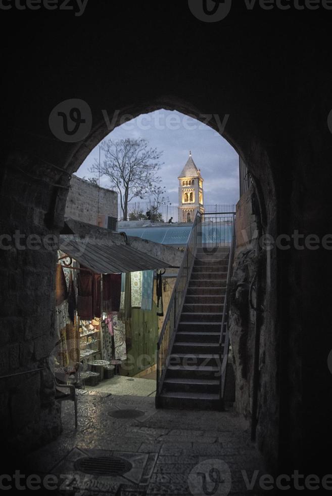 Narrow street with shops and stairs in the old Jerusalem in the evening photo