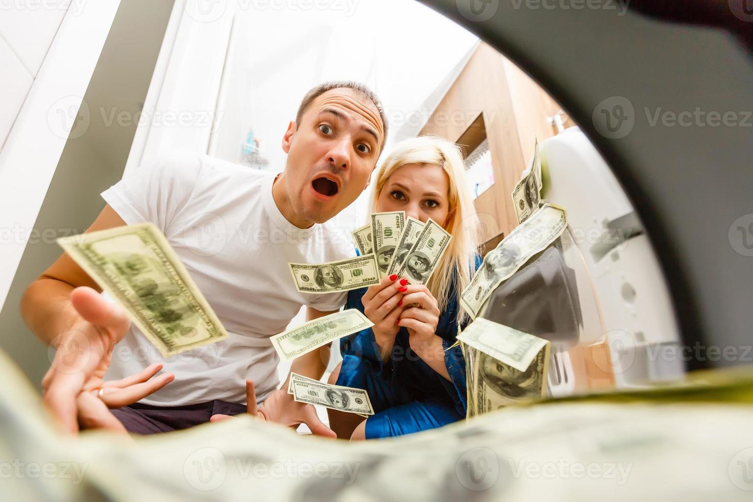 Female putting money into washing machine, closeup photo