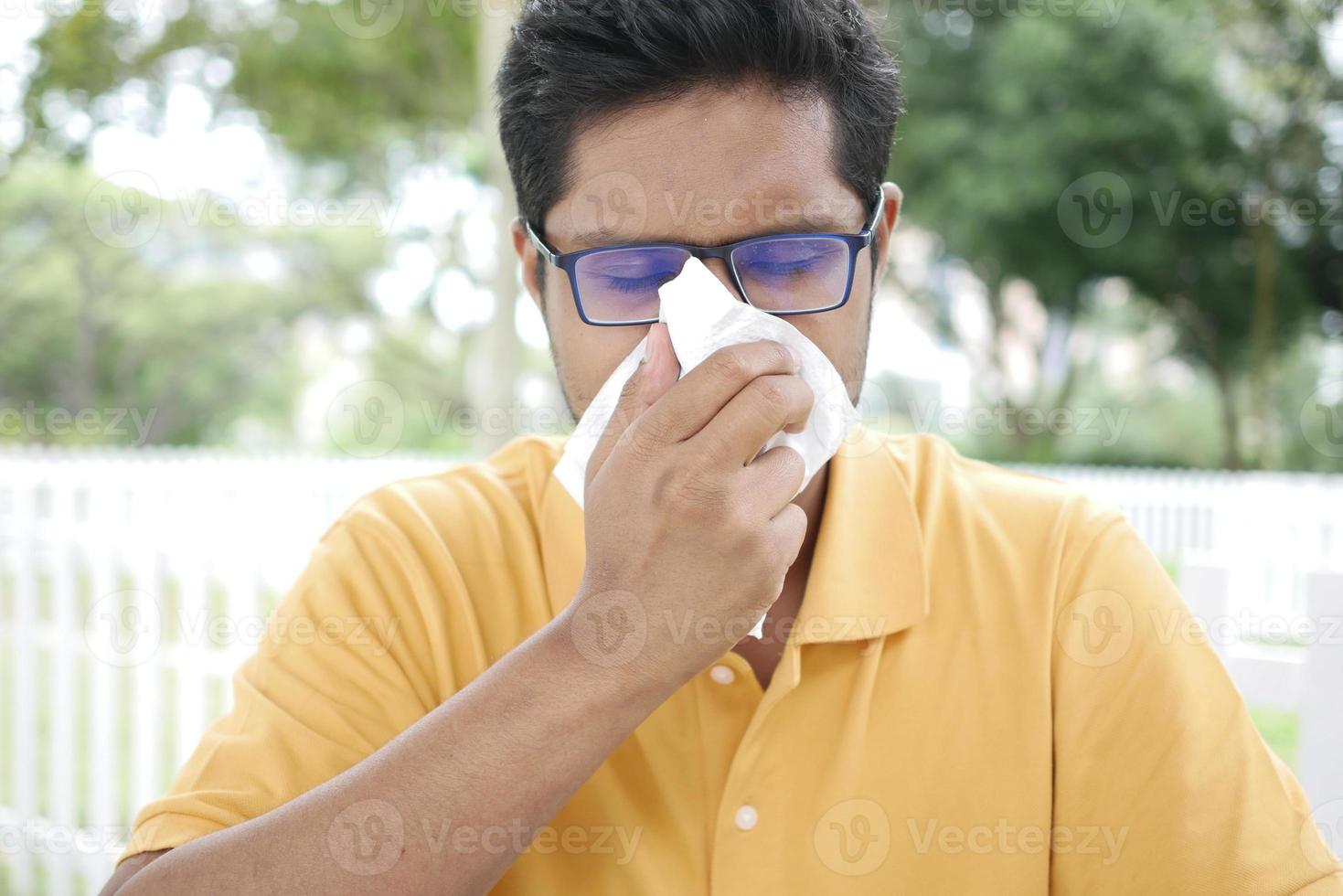 Sick man got flu allergy sneezing and blowing nose photo