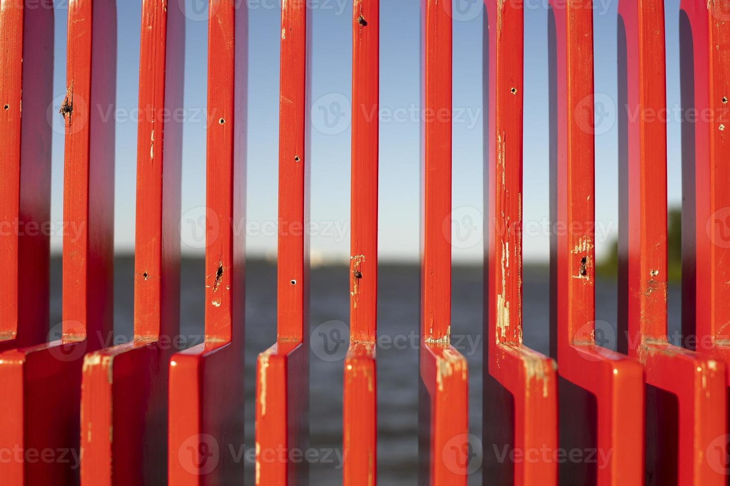 Red bench in detail. Texture of vertical lines. photo