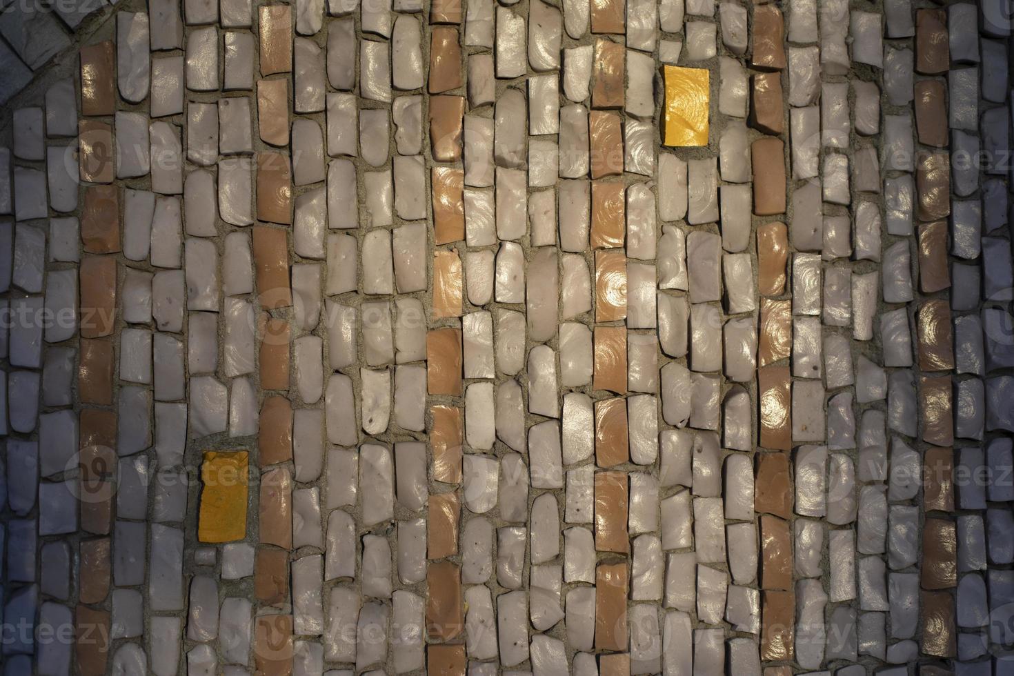 Tiles on wall. Mosaic tile. Pattern of shards of colored stone. photo