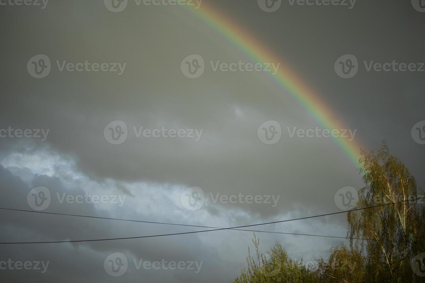 Rainbow in sky. Beautiful weather. Decomposition of light into colors. photo