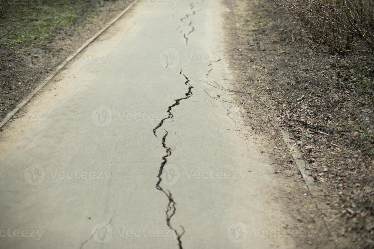 Crack in asphalt. Road with defect. photo