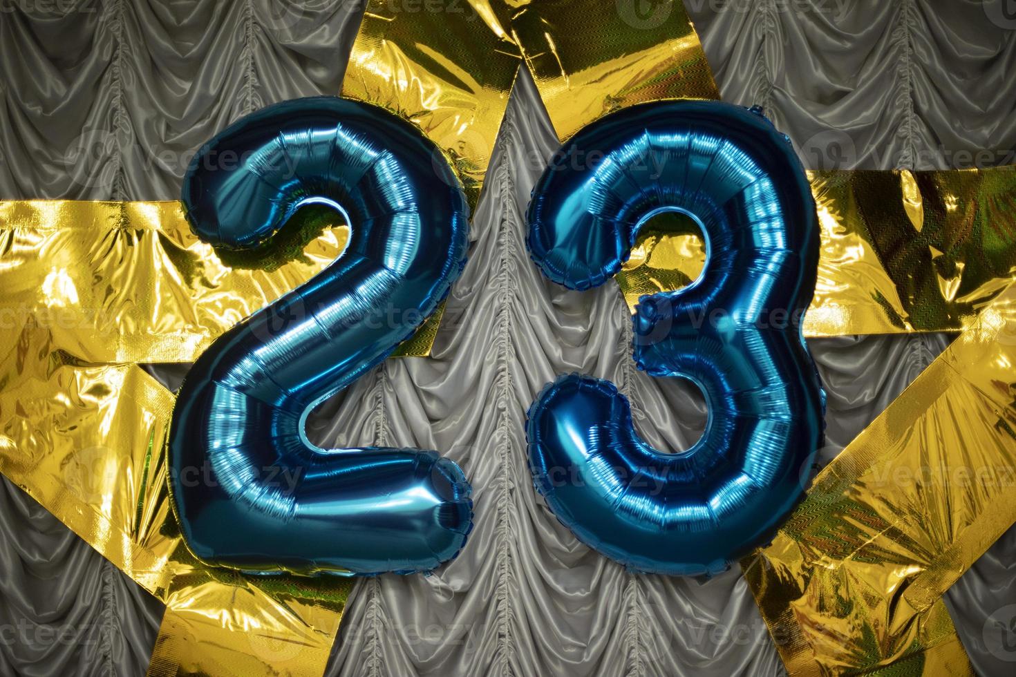 Number 23 of balloons. Decoration with numbers. Star of gold hangs on fabric. photo