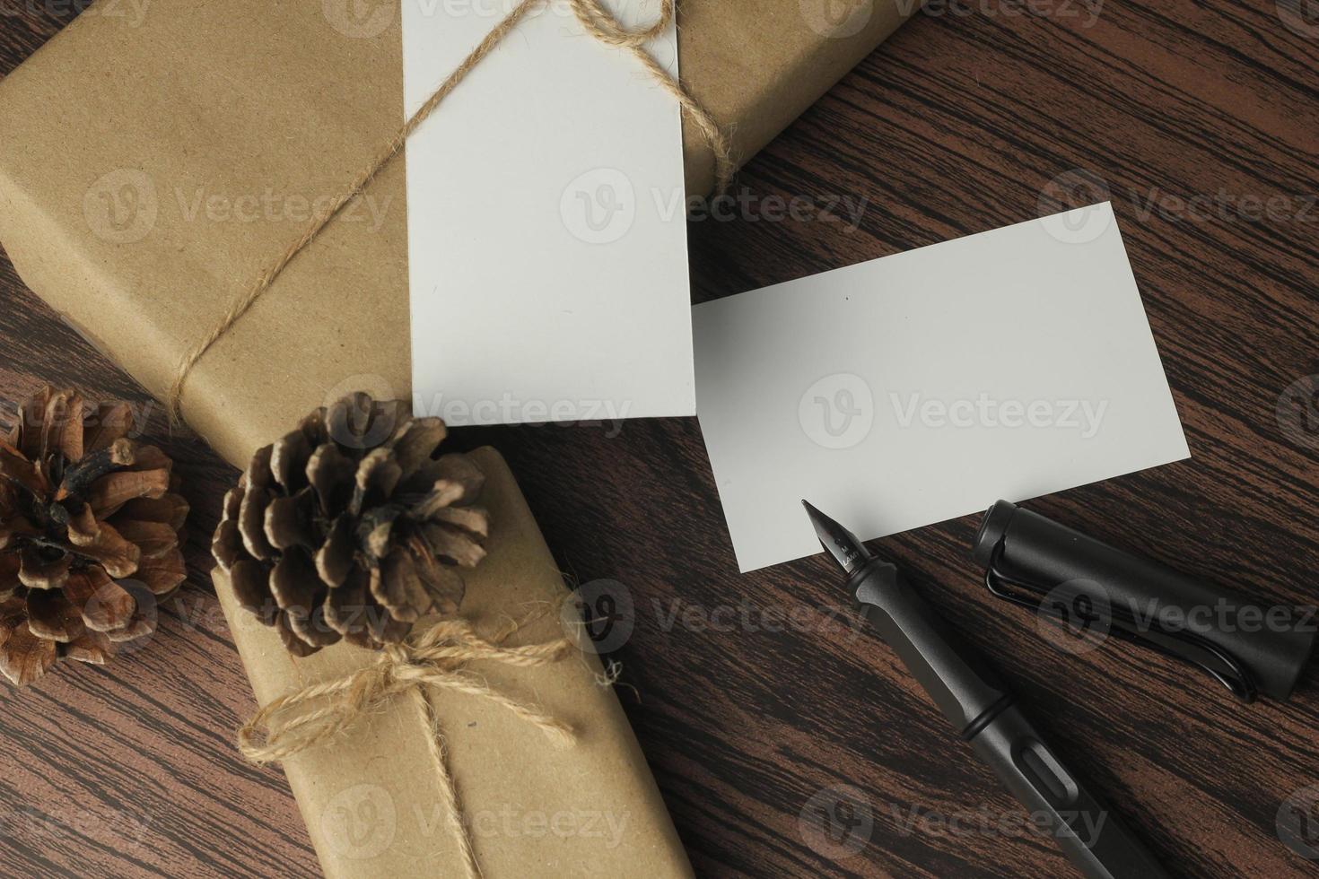 Recycled paper wrapped birthday gift boxes are being prepared on the table, top view, flatlay. photo