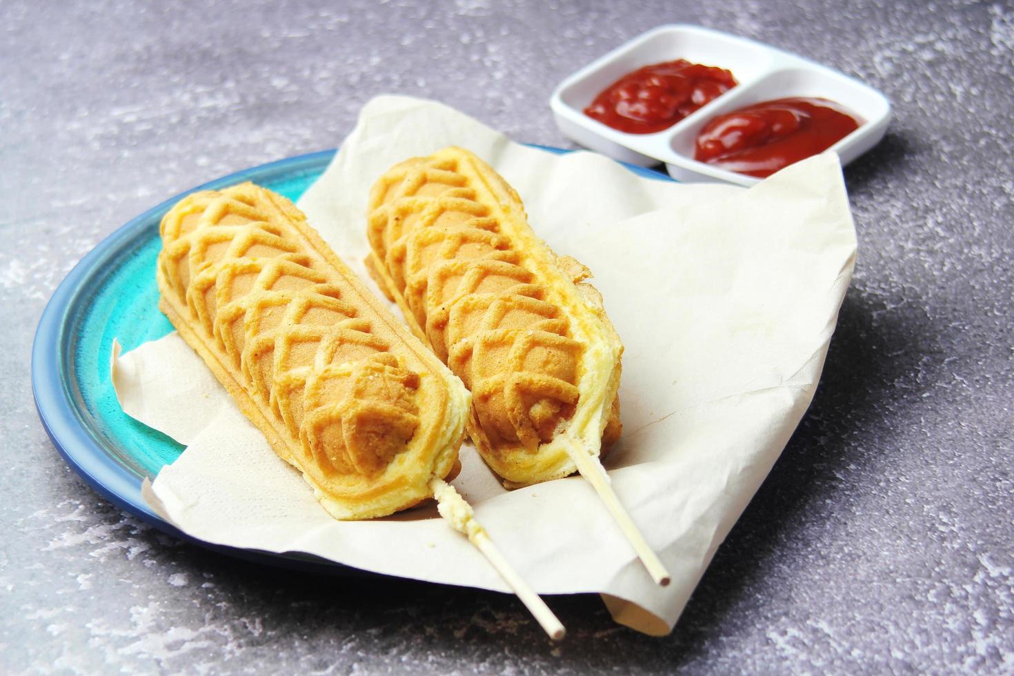 waffle sticks Corn dogs Hot Dog Waffles on a Stick  Ketchup on a wooden table photo