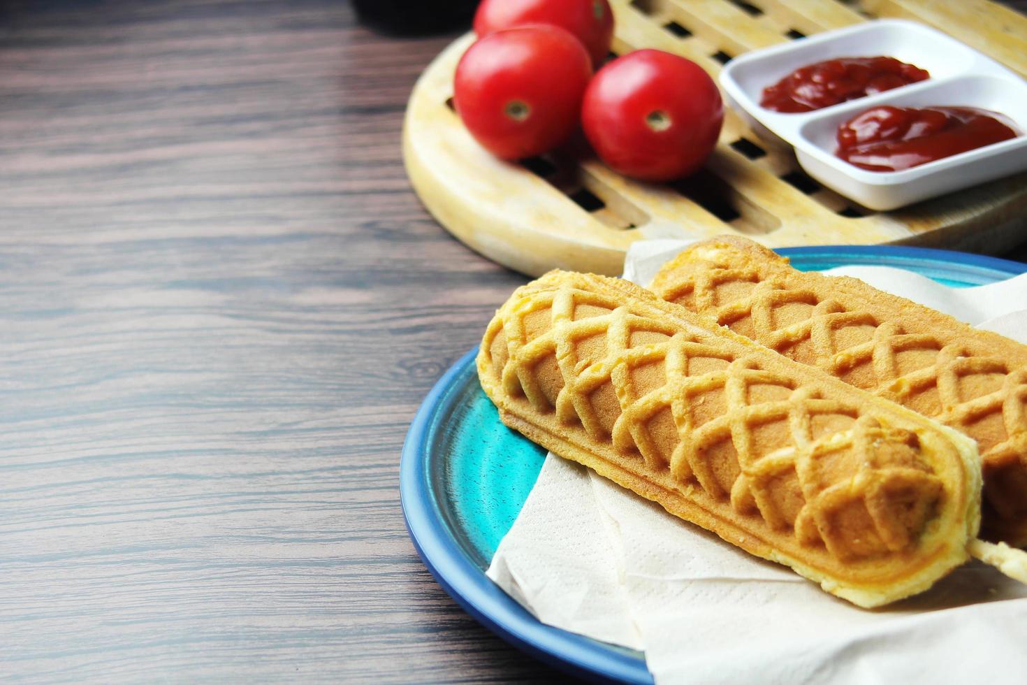 waffle sticks Corn dogs Hot Dog Waffles on a Stick  Ketchup on a wooden table photo