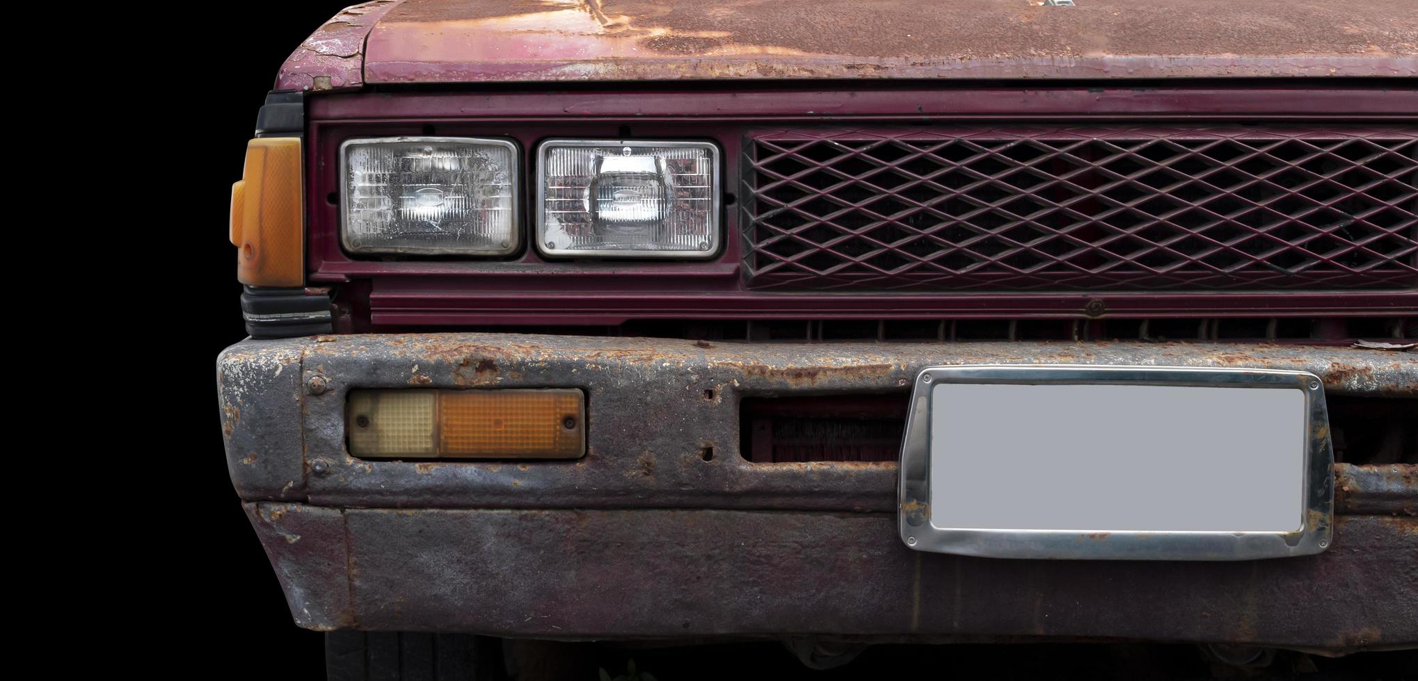 Front view rusty retro car isolated on black blackground photo