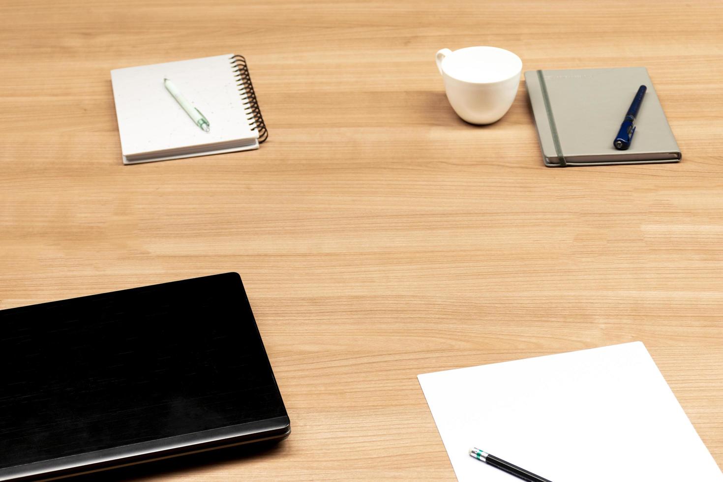 Laptop and notebook on table in meeting room photo