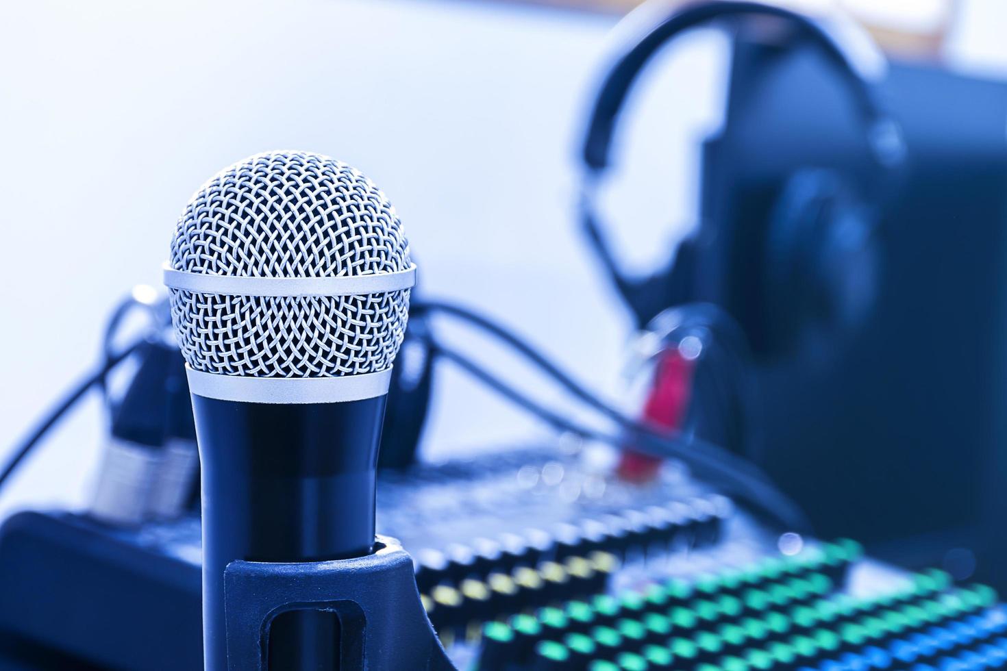 Microphone on tripod with mixer background in sound control room. photo