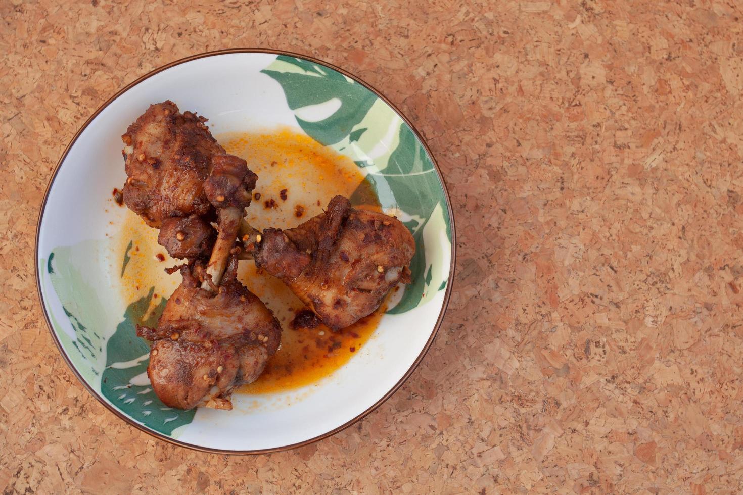 Thai food, chicken leg with mala sauce photo