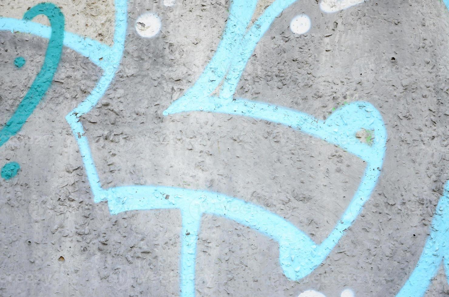 Texture of a fragment of the wall with graffiti painting, which is depicted on it. An image of a piece of graffiti drawing as a photo on street art and graffiti culture topics