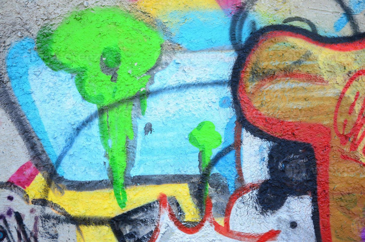 Texture of a fragment of the wall with graffiti painting, which is depicted on it. An image of a piece of graffiti drawing as a photo on street art and graffiti culture topics