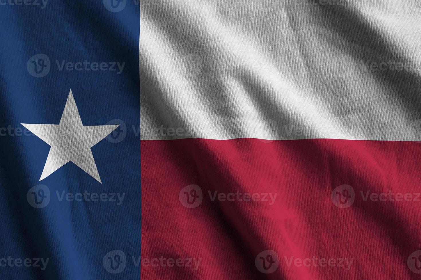 Texas US state flag with big folds waving close up under the studio light indoors. The official symbols and colors in banner photo