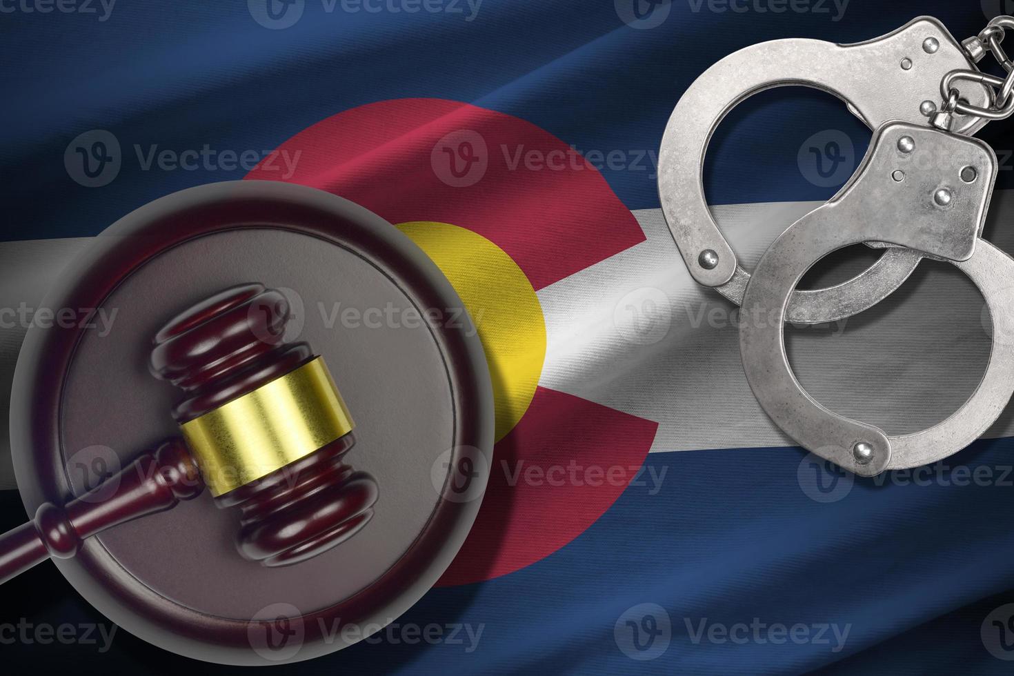 Colorado US state flag with judge mallet and handcuffs in dark room. Concept of criminal and punishment photo