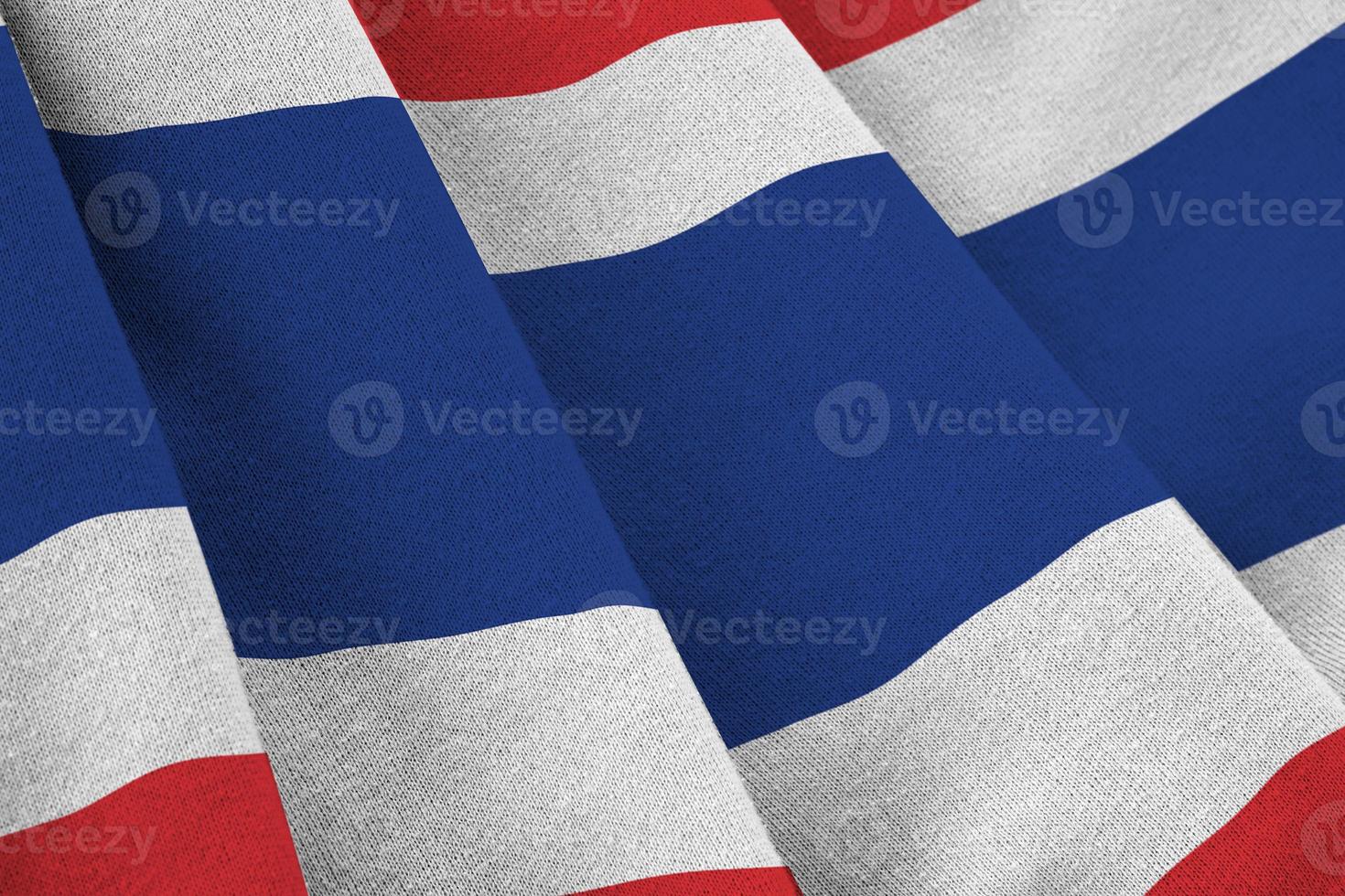 Thailand flag with big folds waving close up under the studio light indoors. The official symbols and colors in banner photo