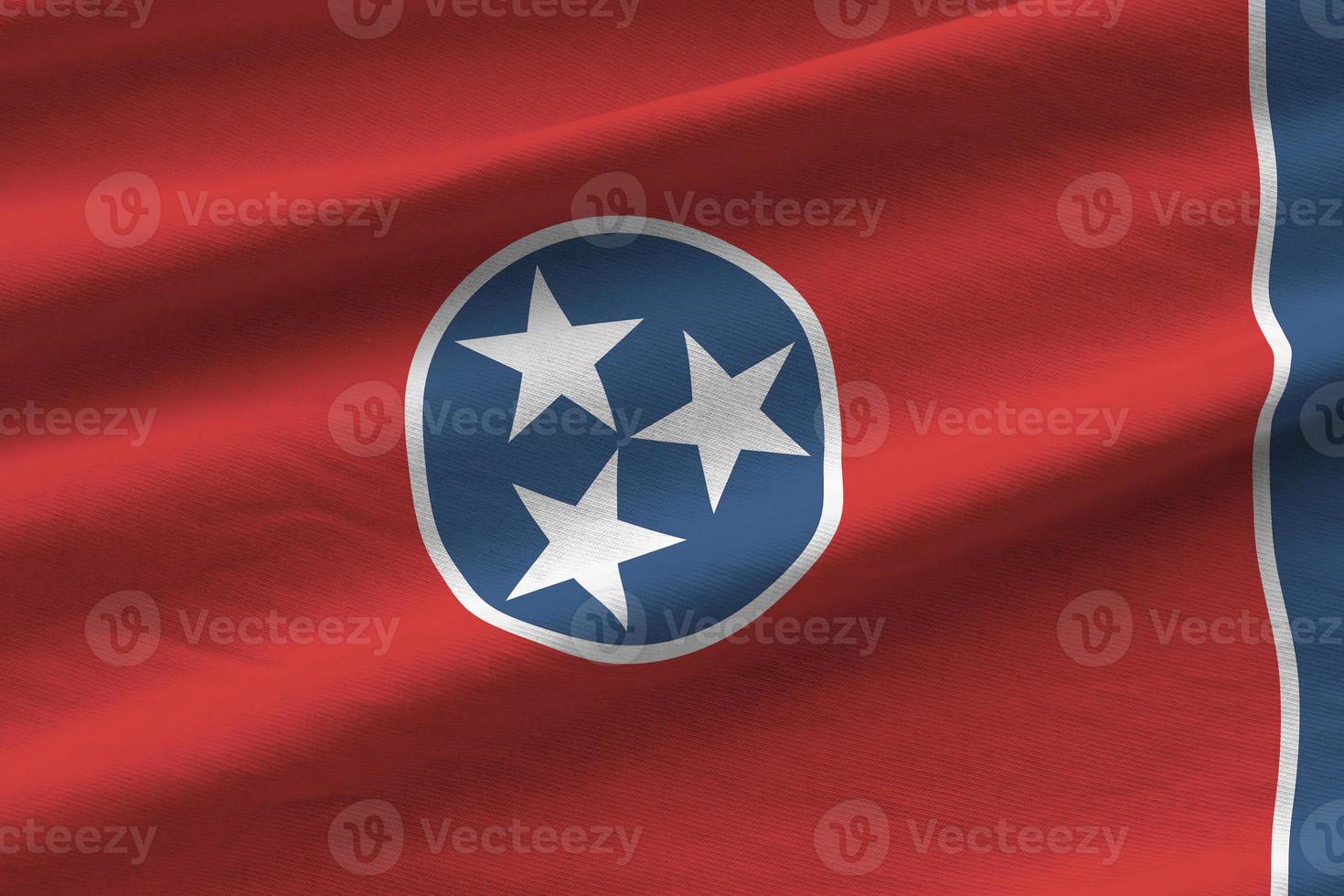 Tennessee US state flag with big folds waving close up under the studio light indoors. The official symbols and colors in banner photo