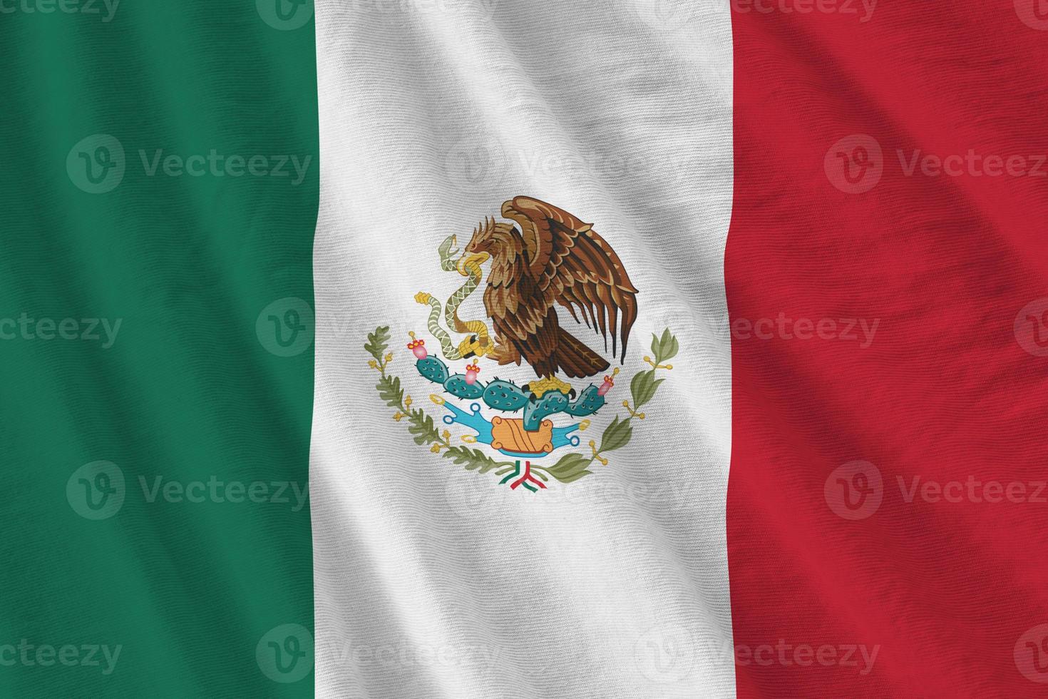 Mexico flag with big folds waving close up under the studio light indoors. The official symbols and colors in banner photo