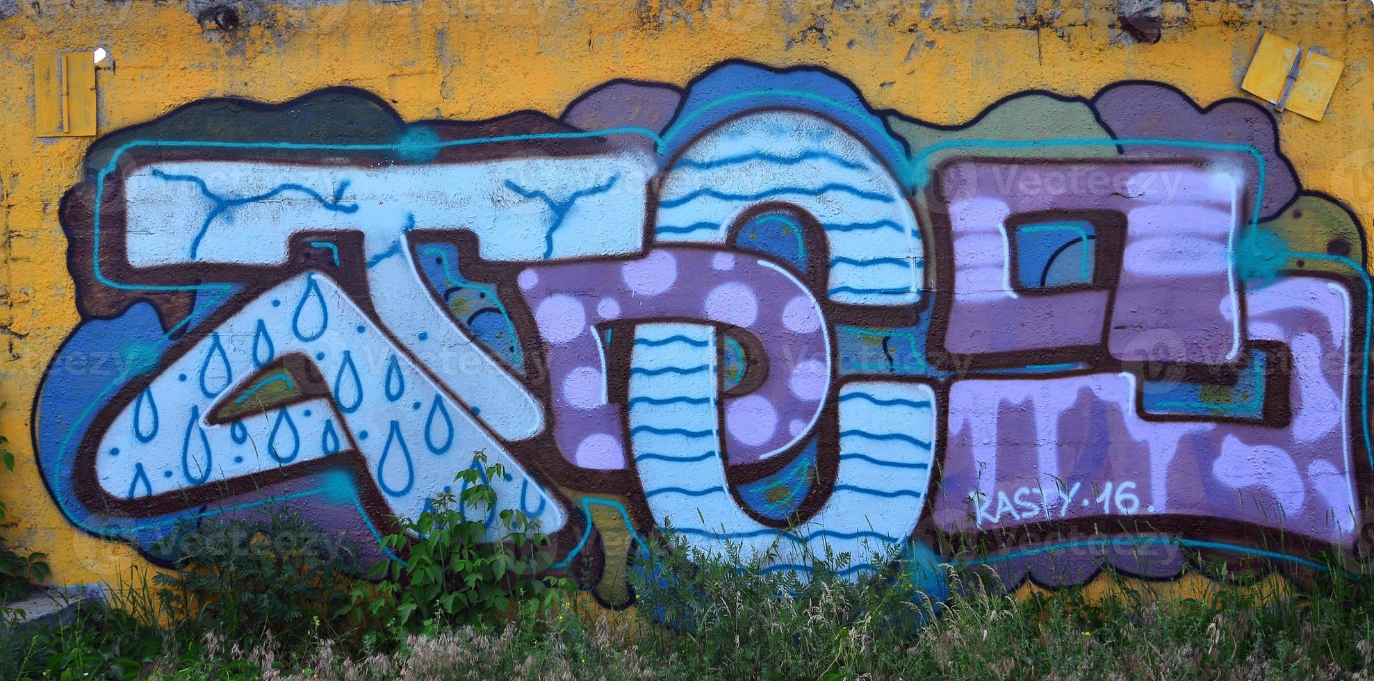 Street art. Colorful graffiti on the wall. Fragment for background. Abstract detail of a graffiti photo