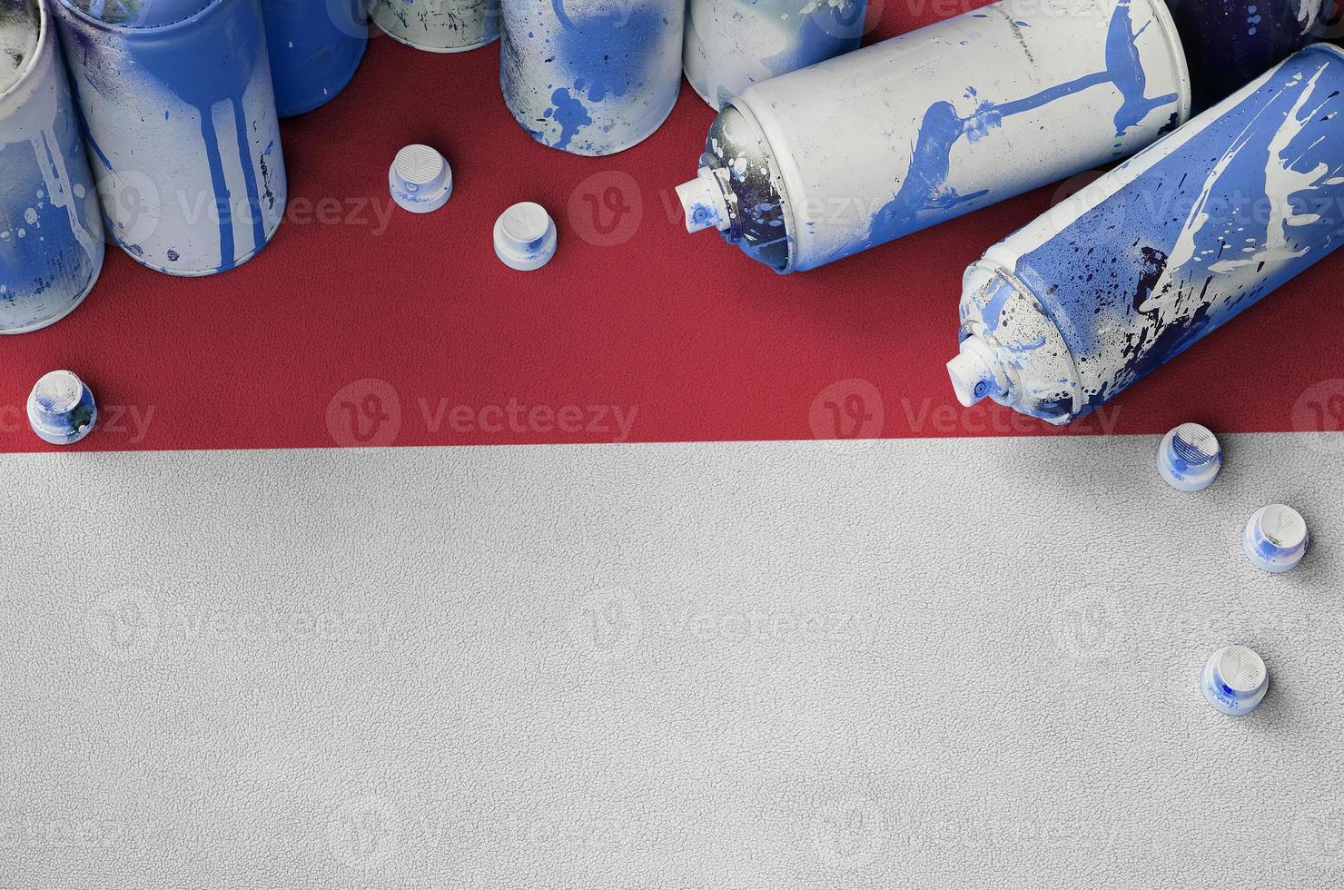 Indonesia flag and few used aerosol spray cans for graffiti painting. Street art culture concept photo