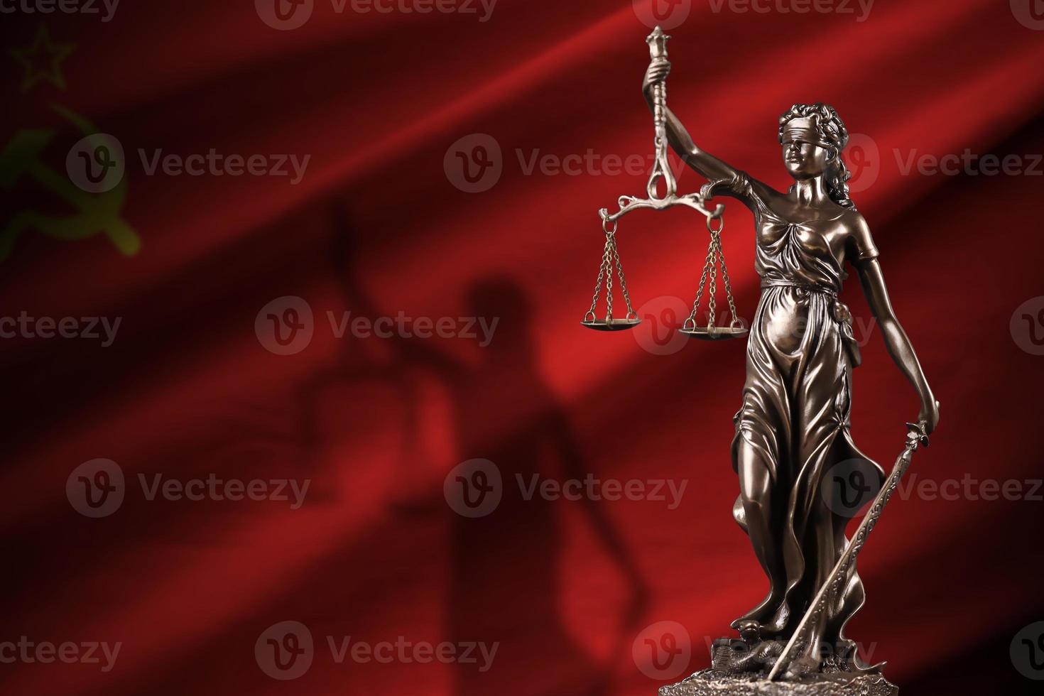 Soviet Union flag with statue of lady justice and judicial scales in dark room. Concept of judgement and punishment photo