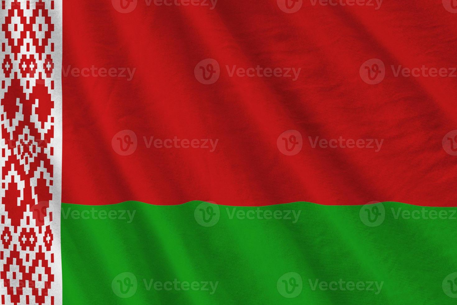 Belarus flag with big folds waving close up under the studio light indoors. The official symbols and colors in banner photo