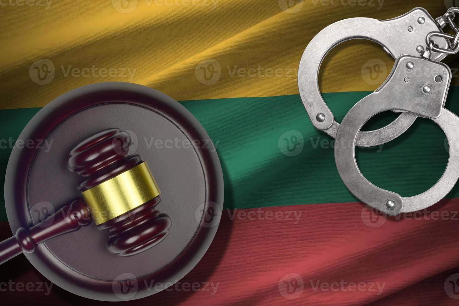 Lithuania flag with judge mallet and handcuffs in dark room. Concept of criminal and punishment, background for judgement topics photo