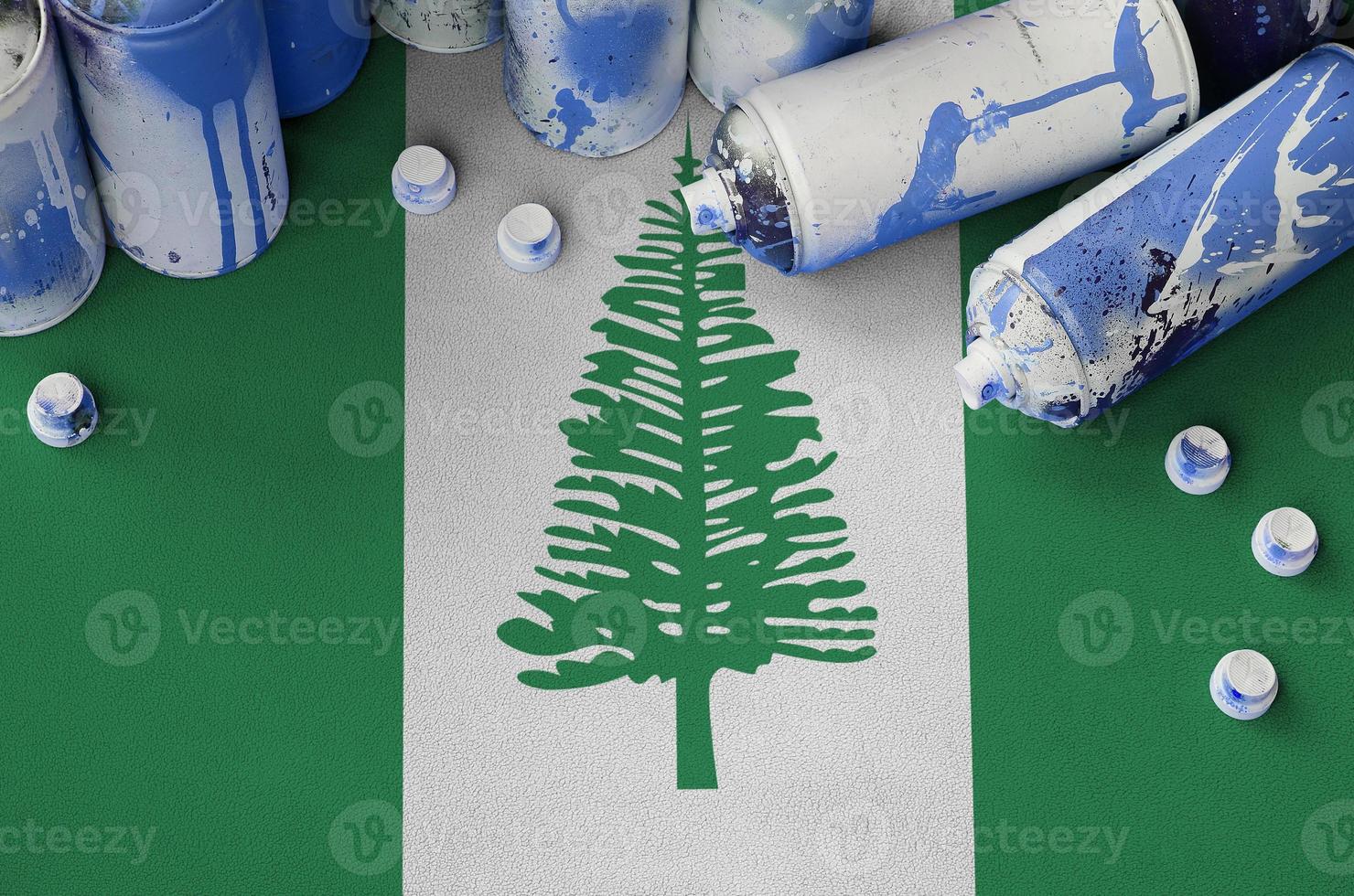 Norfolk island flag and few used aerosol spray cans for graffiti painting. Street art culture concept photo