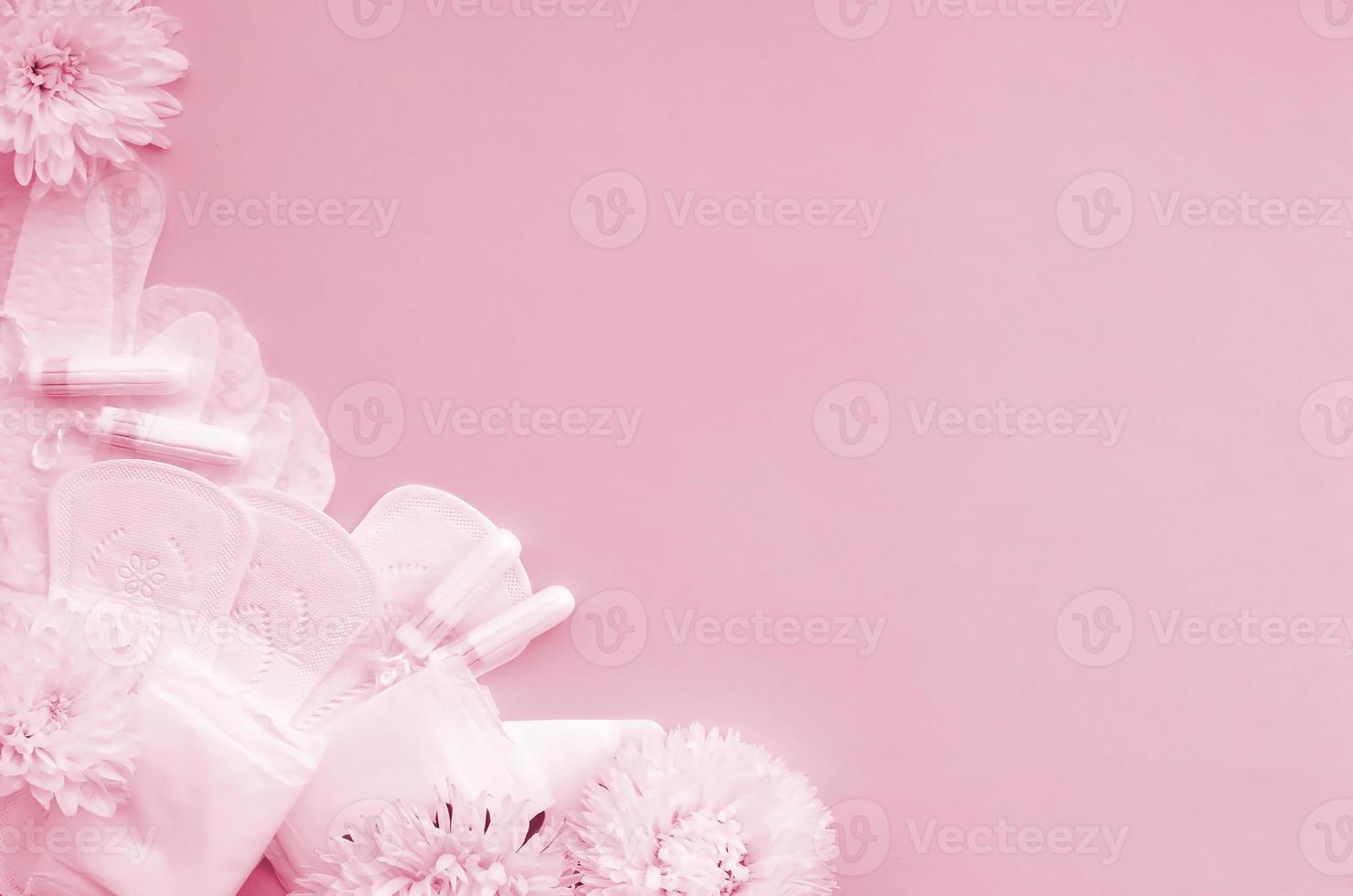 Menstrual pads and tampons with tender white flowers on pastel lilac background Image toned in Viva Magenta, color of the 2023 year photo
