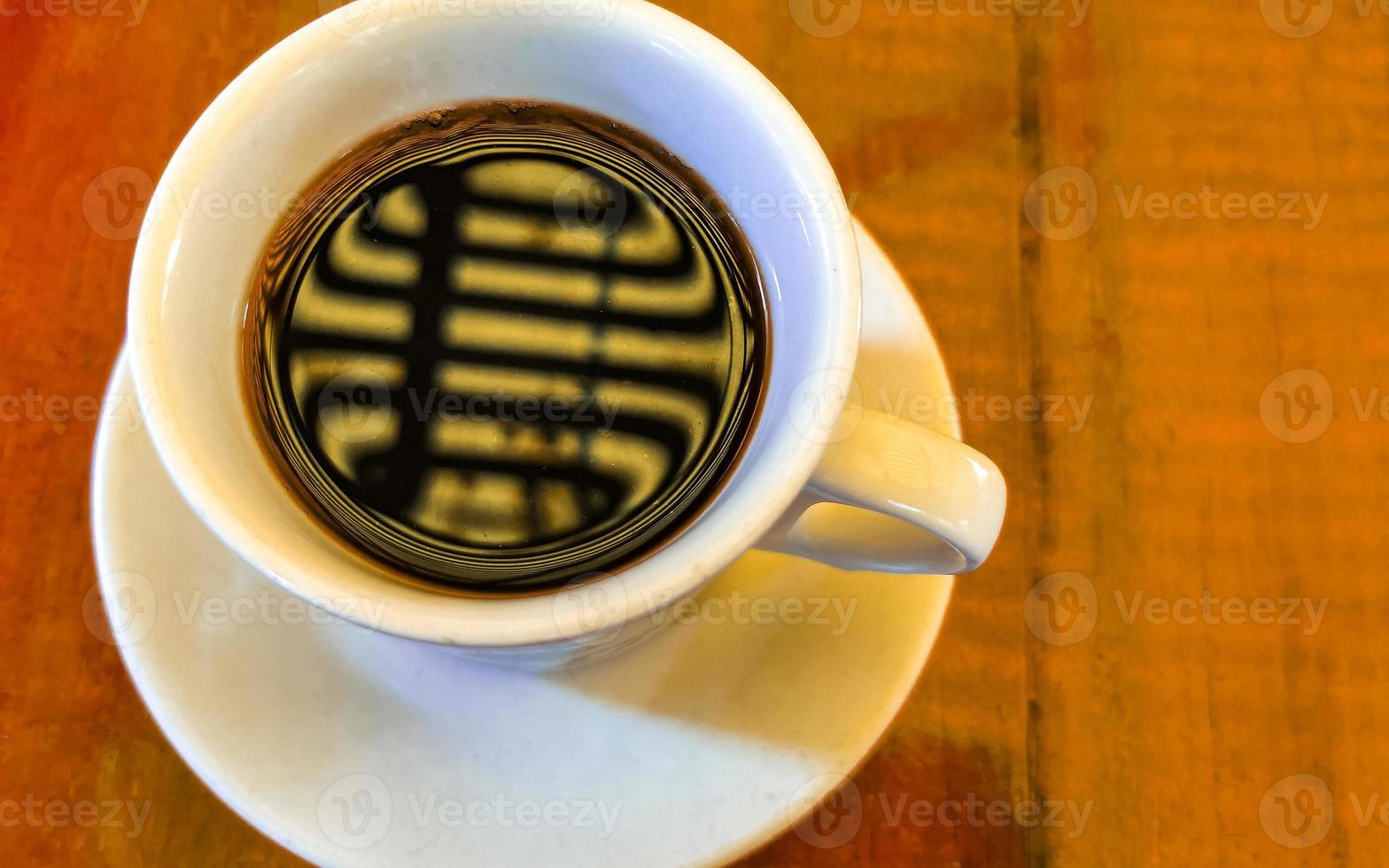 Blue white cup pot with black coffee wooden table Mexico. photo