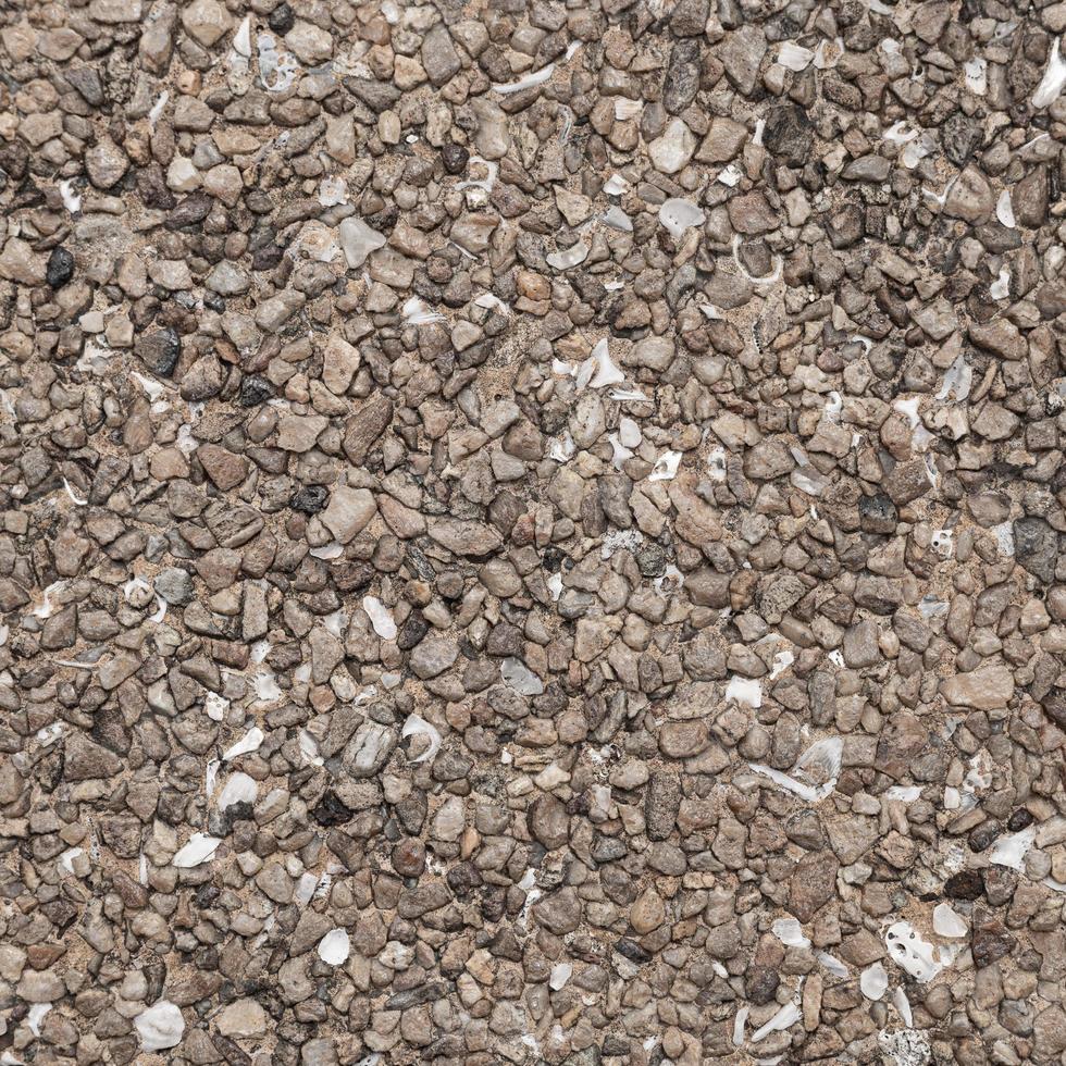 The pattern small brown pebbles stone as background. pebbles texture wall and floor. photo