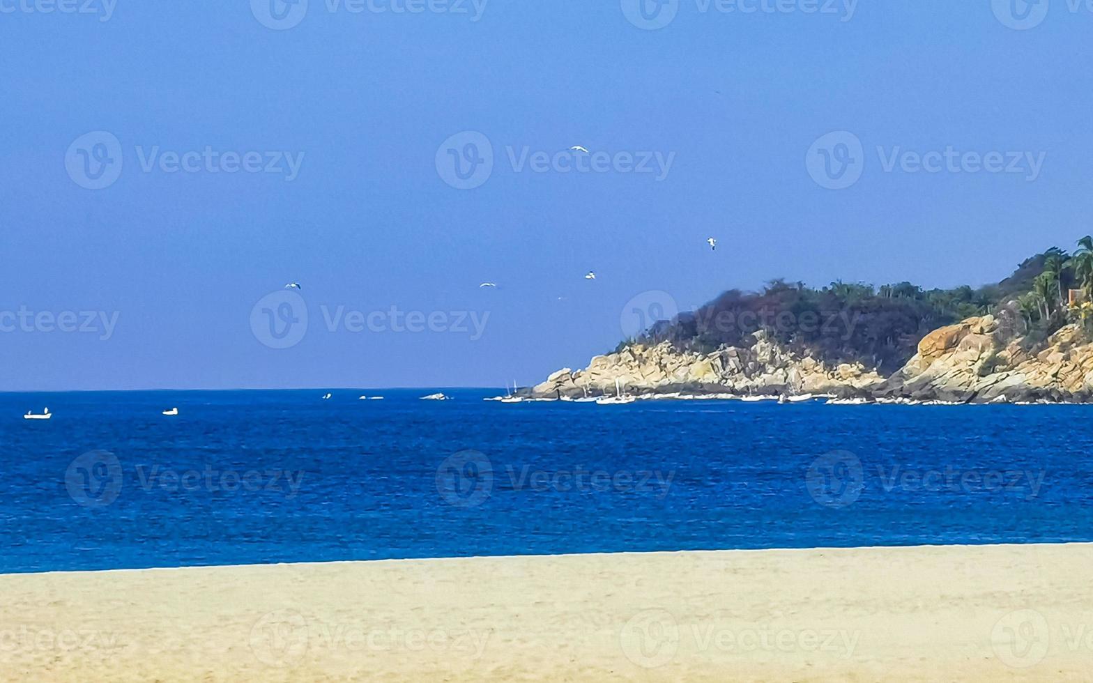 Beach sand blue water huge surfer waves Puerto Escondido Mexico. photo