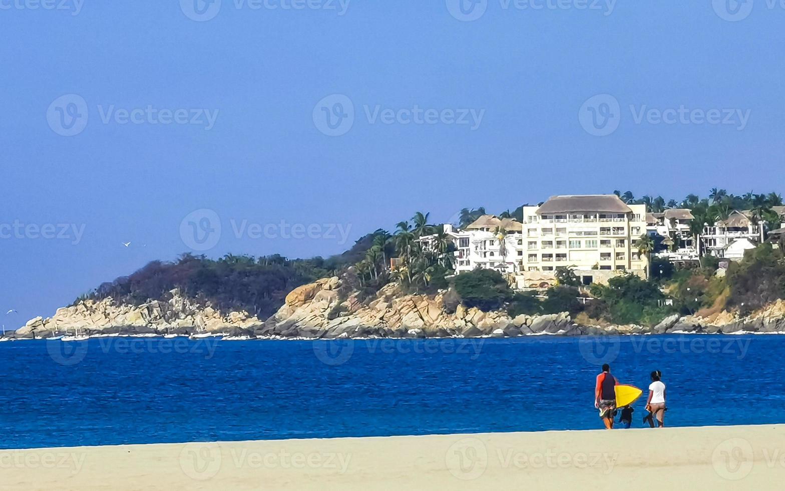 Beach sand blue water huge surfer waves Puerto Escondido Mexico. photo