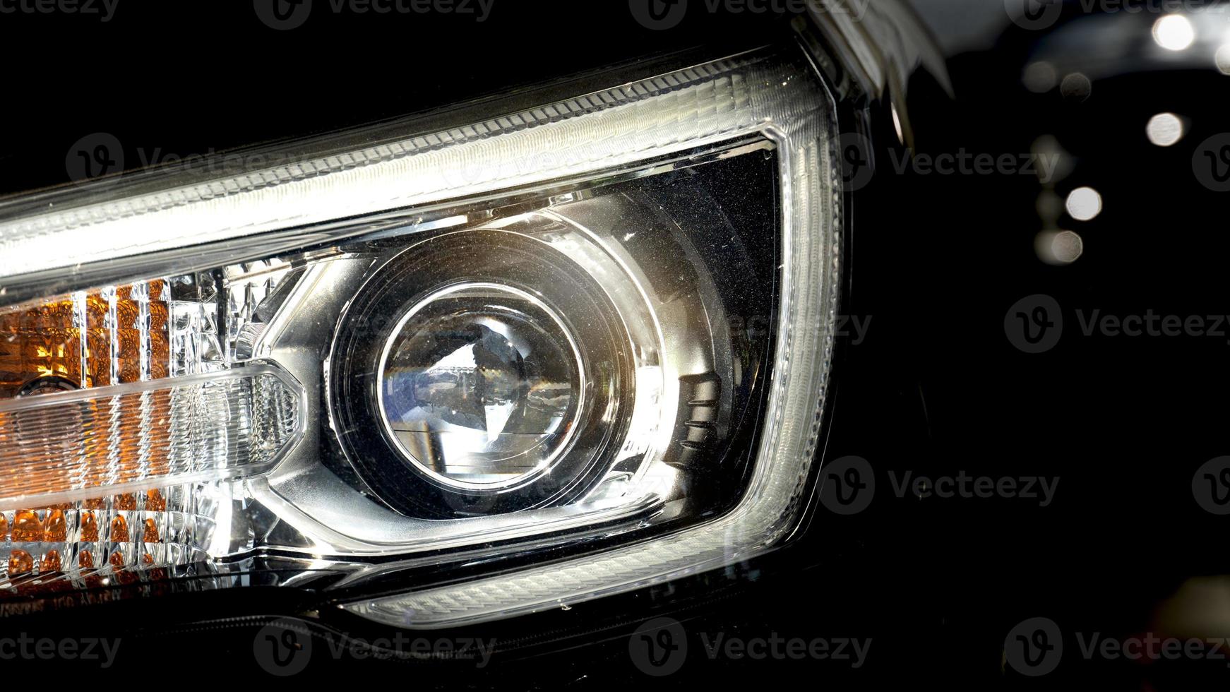 Abstract dark tone of headlights of black car is aggressive and gorgeous. photo