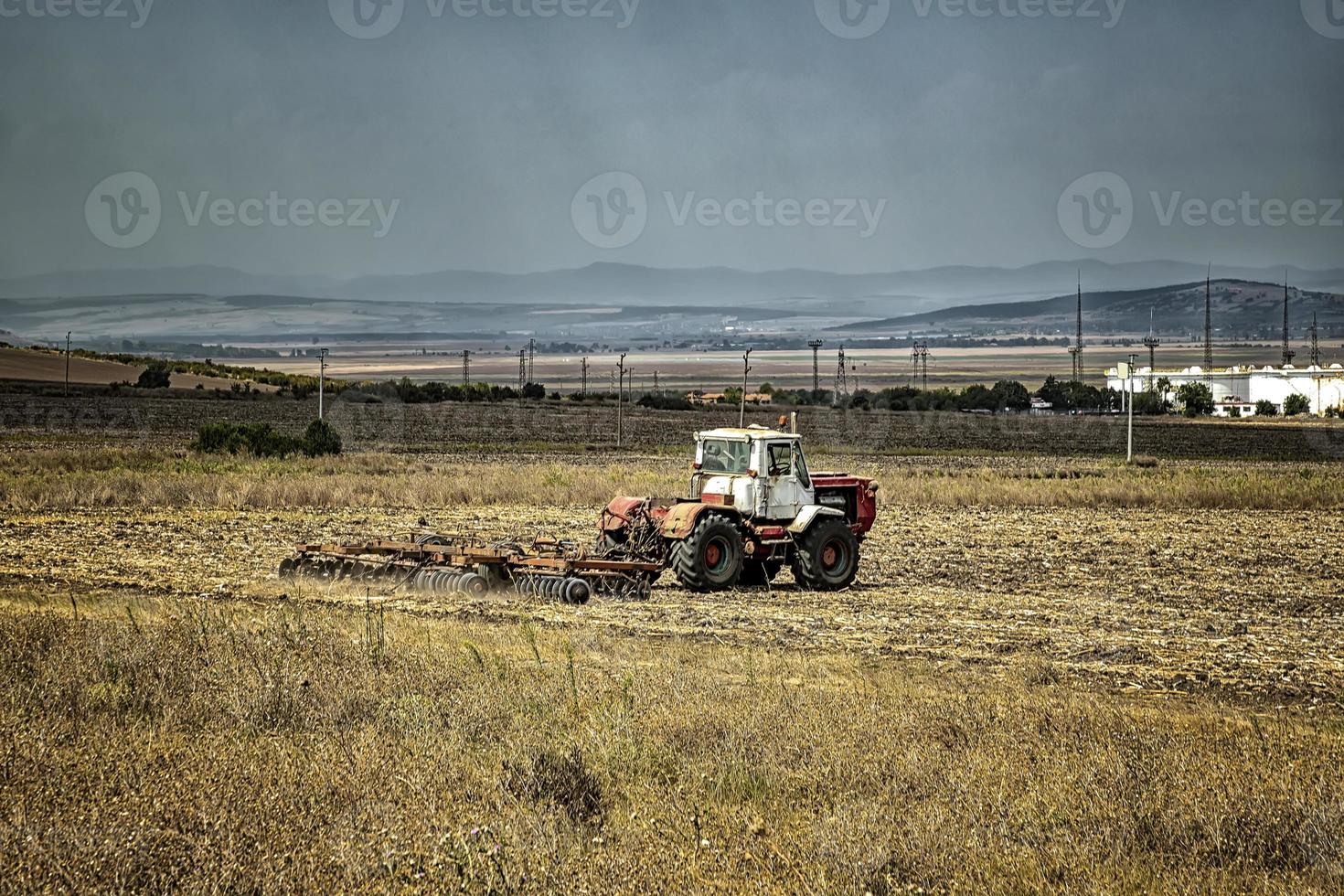 The tractor prepares the ground for sowing and cultivation. Agriculture and agronomy concept. photo