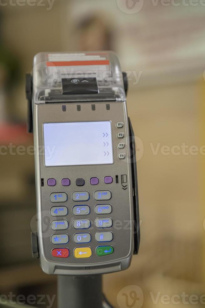 card payment terminal POS terminal at a shop, close up. Blurred background photo