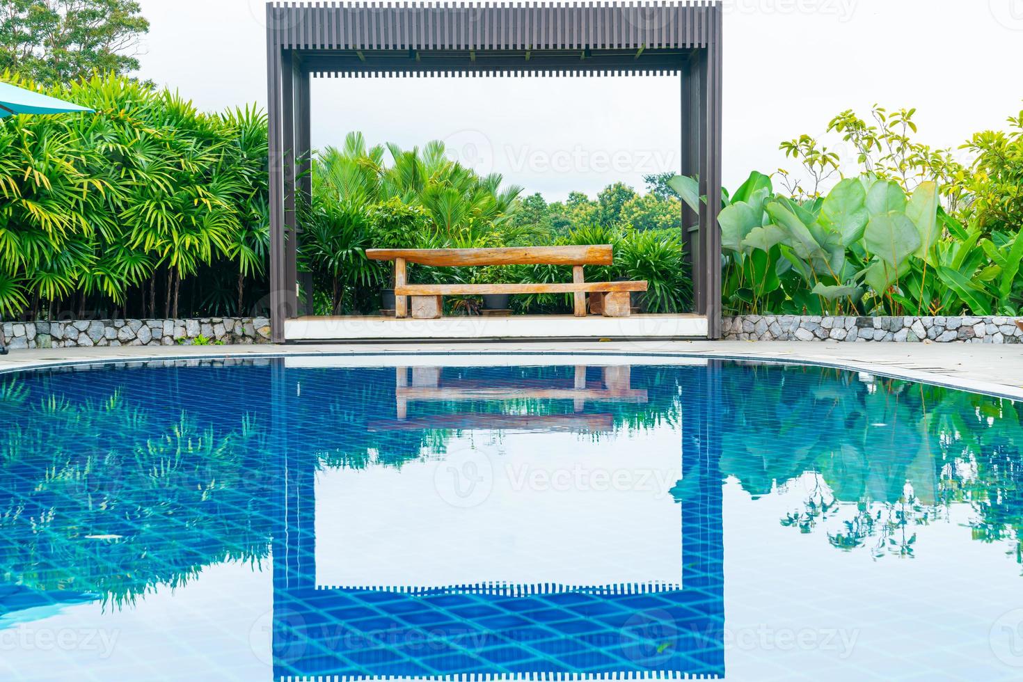 empty wood bench on poolside photo